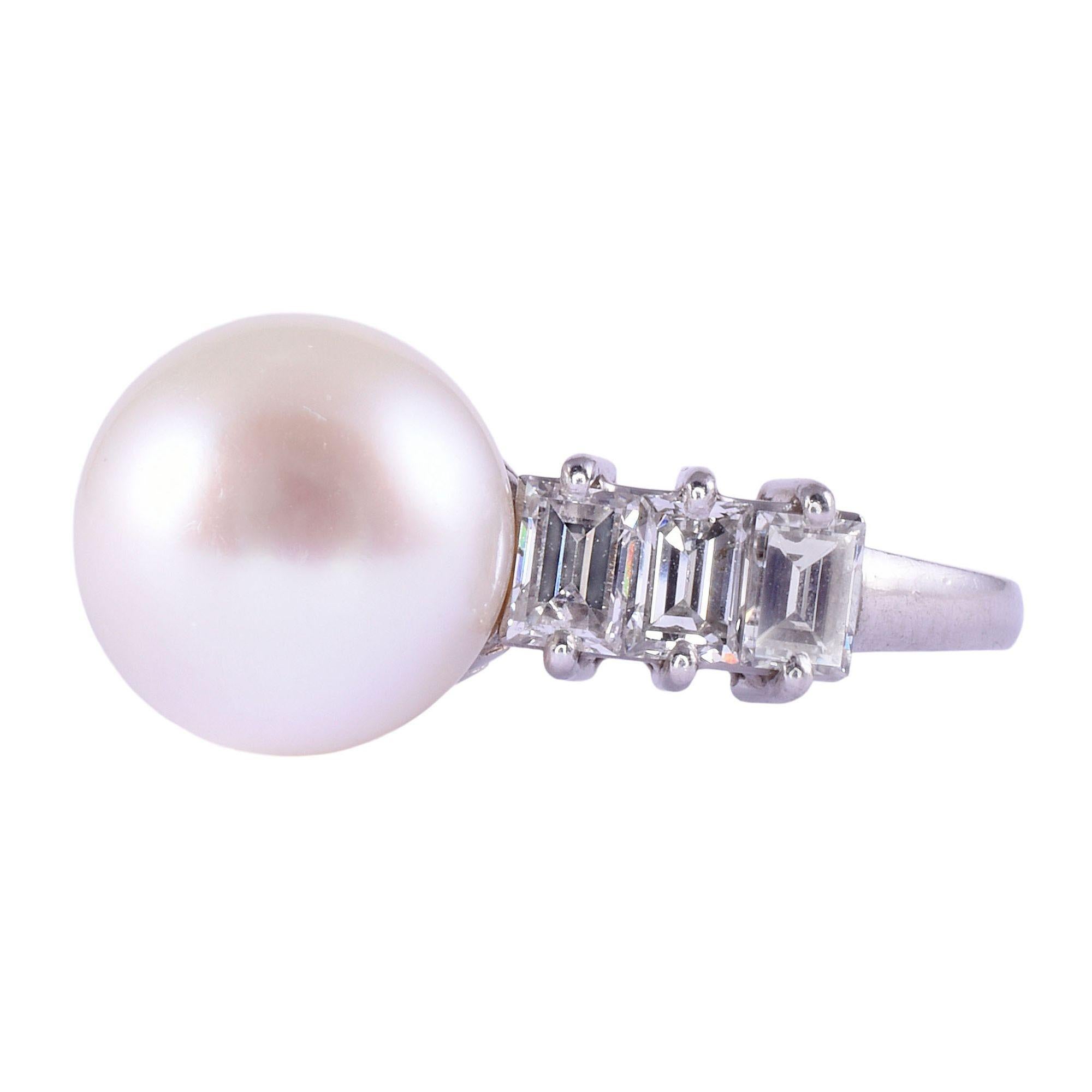 Vintage Akoya pearl & baguette diamond platinum ring, circa 1960. This vintage pearl ring is crafted in platinum and features a 9.9mm Akoya pearl. The Akoya pearl ring is accented with .90 carat total weight of baguette diamonds with VS clarity and