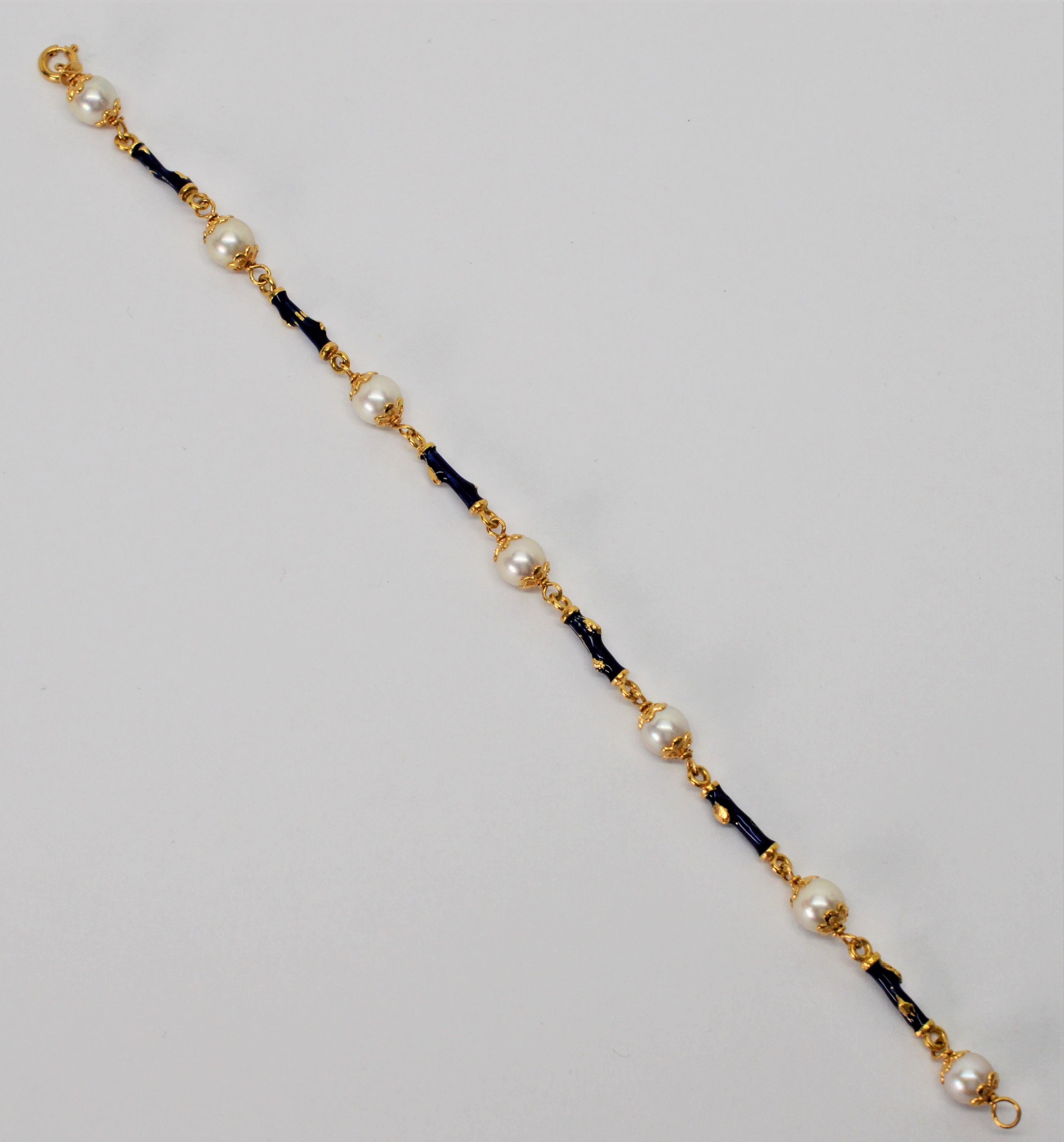 Delicate twig shaped links with blue enamel accents made of eighteen karat yellow gold alternate with creamy white AAA  Akoya pearl buds to create this eight inch (8