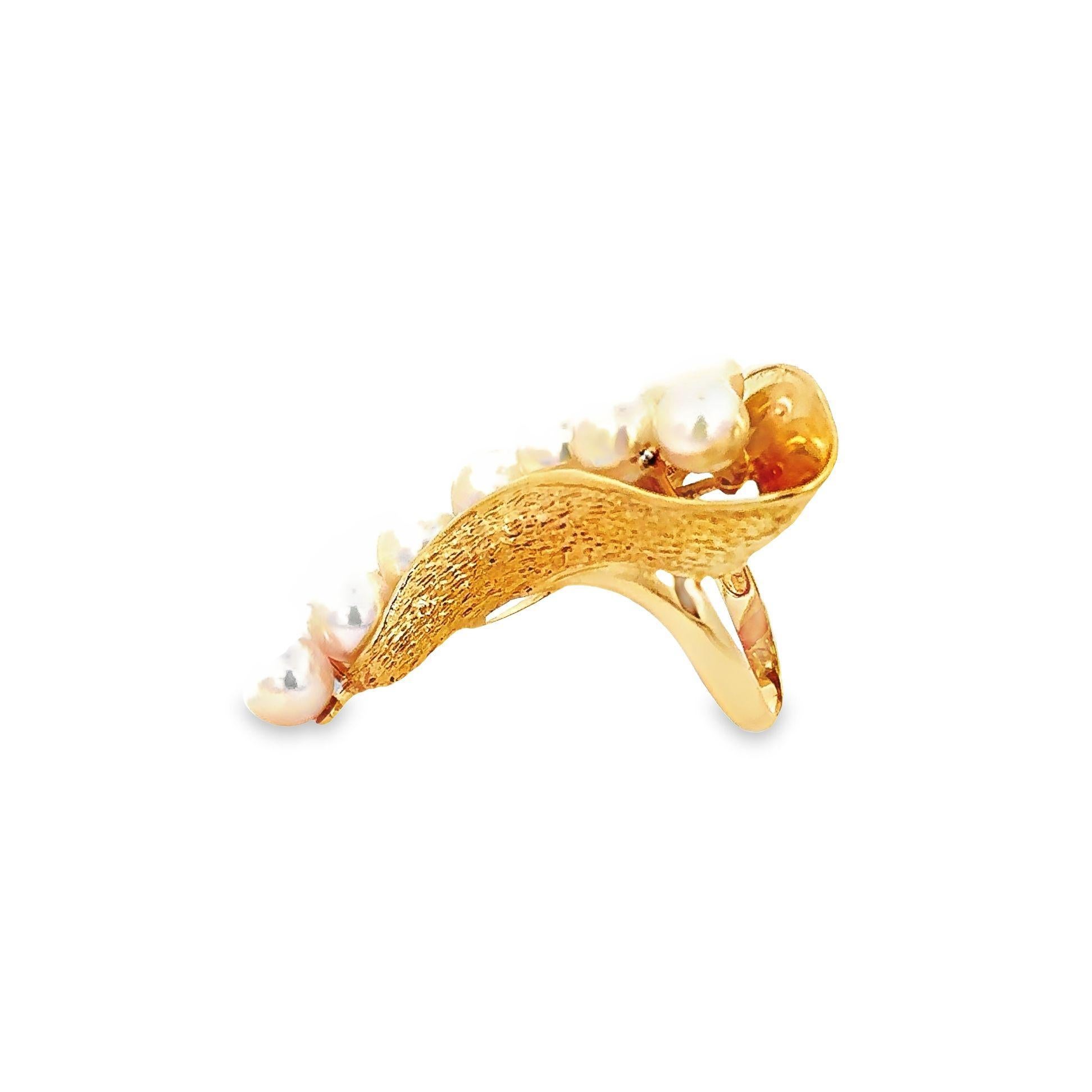 A unique cocktail ring featuring 13 extremely fine Japanese Akoya pearls. The pearls measure 6.5mm each and all have extremely fine nacre quality and luster, along with a strong rosy pink overtone making the pearls appear to glow in the light.