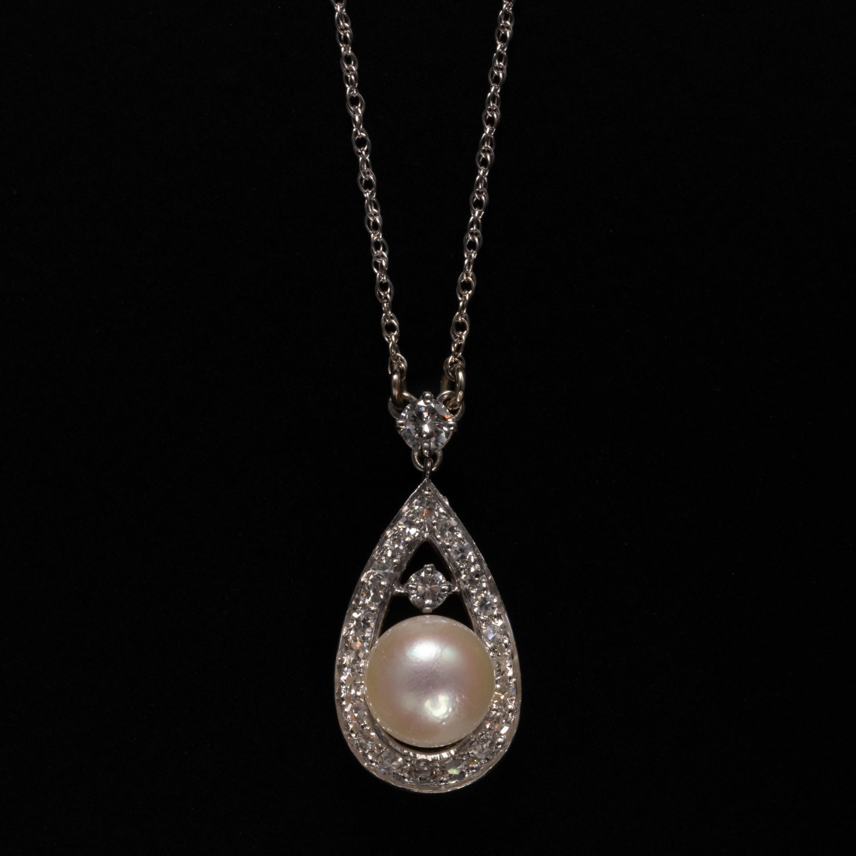 A luminous creamy cultured 7.16mm cultured Akoya pearl with a light pink overtone is the focal point of this hand-crafted 18K white gold pear-shaped pendant. 

Twenty-two tiny, sparkling white diamonds frame the pearl and one rests atop it. A .10