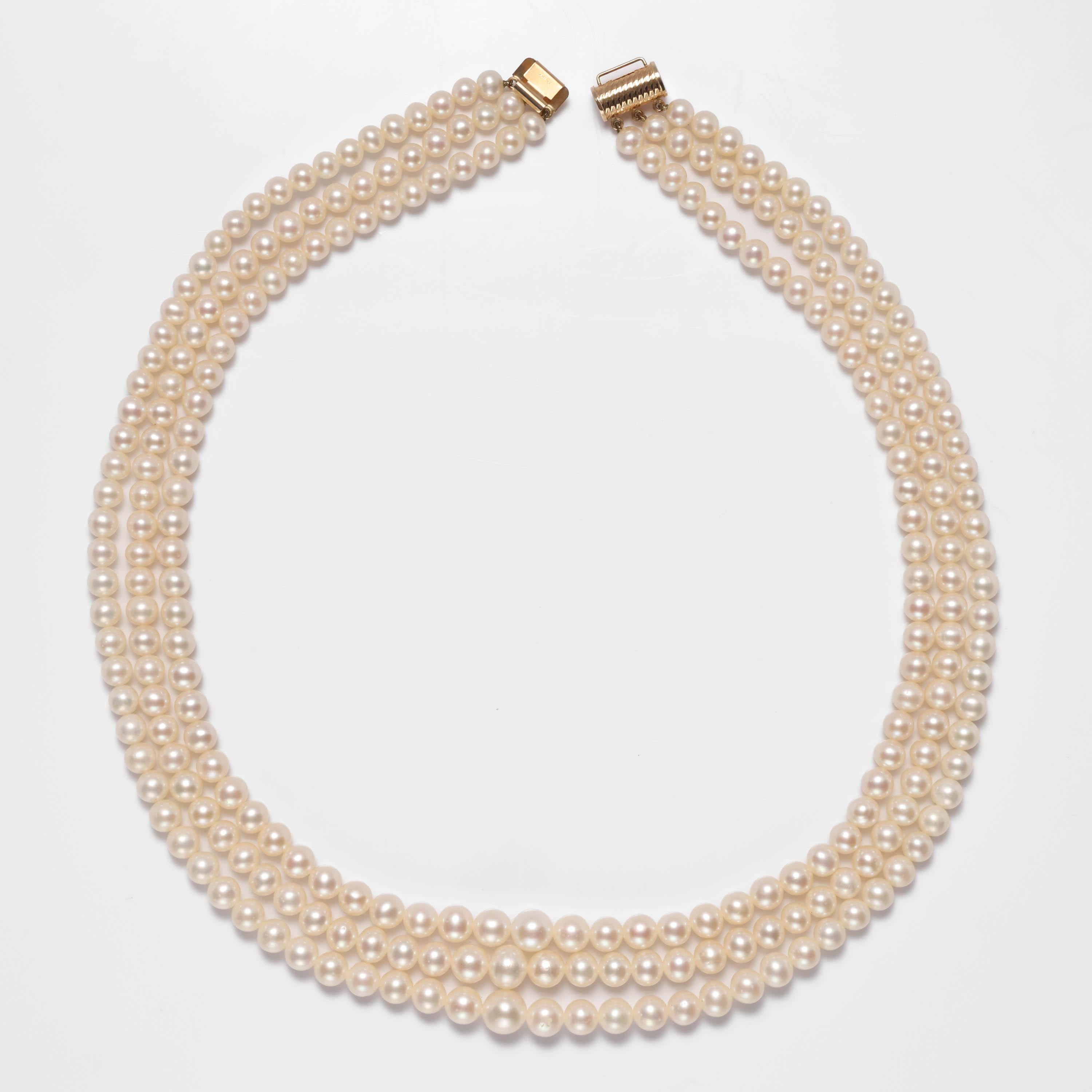 This triple-strand cultured Akoya pearl necklace hails from the glamorous early 1970s. Think: Lauren Hutton, Halston, Studio 54. 

The necklace is entirely original and in pristine condition. The gleaming, lustrous cultured Akoya sea pearls range in