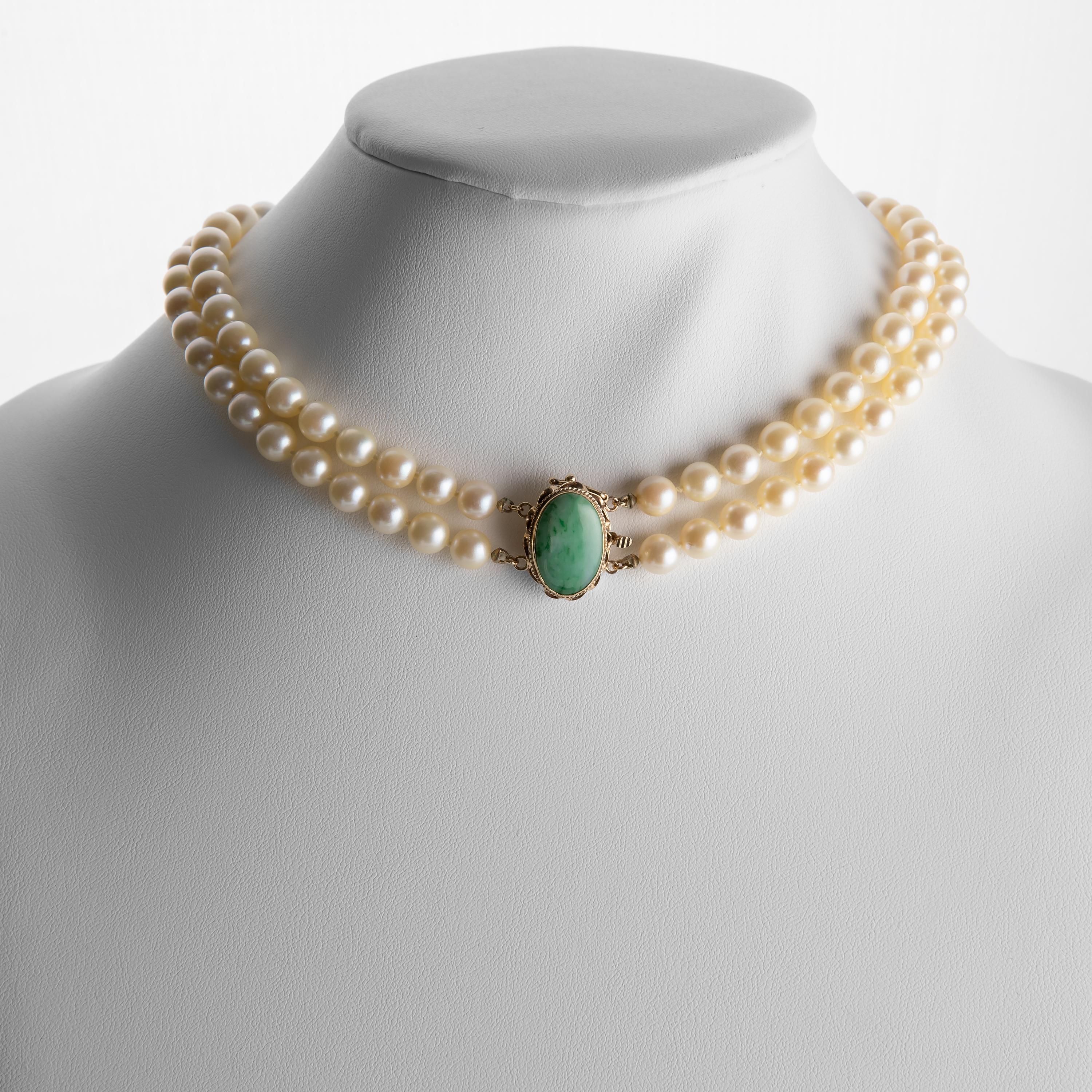 This double strand of cultured Akoya pearls of impressive size —7mm - 8.13mm— is a timeless classic. Created in America in the 1950s or thereabouts, this necklace features a handmade 14K gold clasp that has been set with a certified untreated