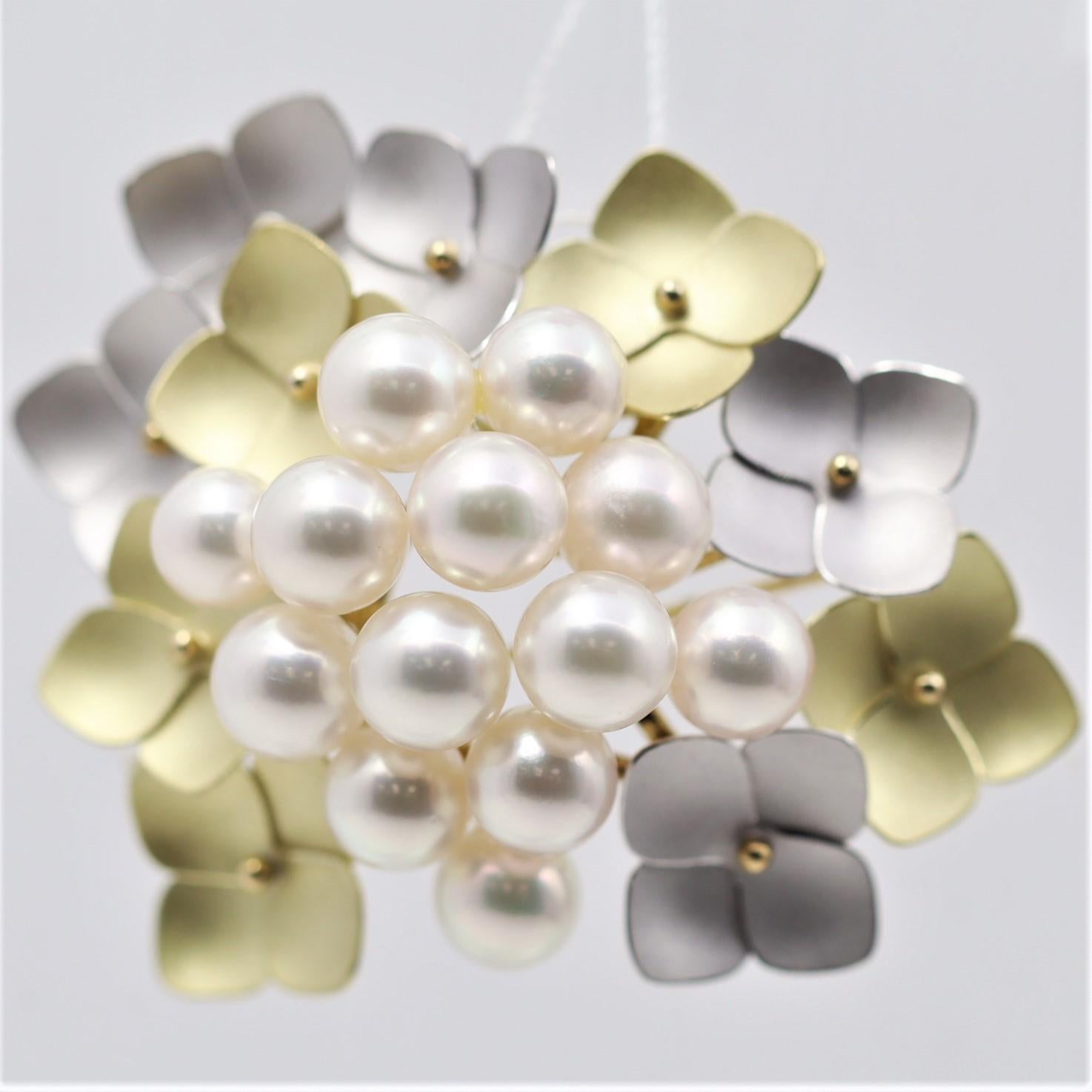 A delightful piece featuring a cluster of extra fine Akoya pearls with excellent nacre quality and a lovely pink overtone which makes the pearls glow. It is surrounded by hand sculpted gold flowers made in both 18k yellow gold and 14k white gold