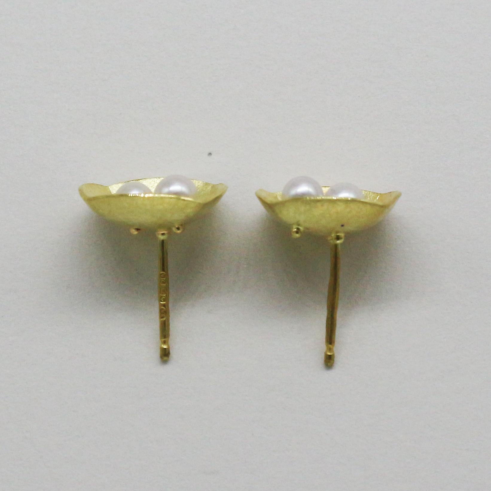 This 18ct gold and Akoya pearl earrings are all hand crafted. Akoya pearls are cultured in Japan and they have a high luster. The earring have a delicate texture of gold that gives a soft warm feel to the piece, with only the polished edges