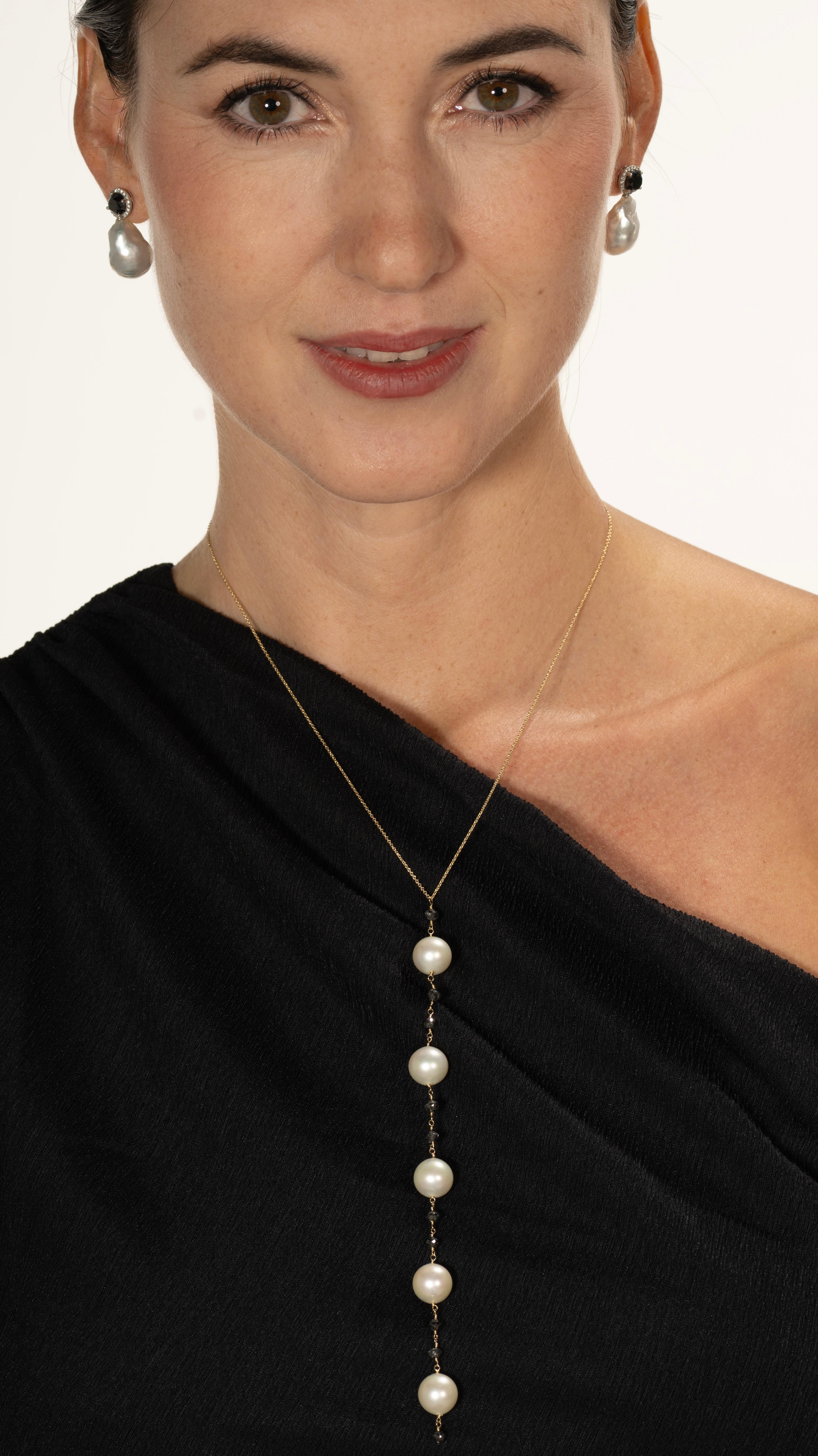 The Nyx necklace is a bold yet graceful line of contrast—handcrafted in 18k gold, featuring luminous pearls and faceted black diamonds that shimmer like stars in a dark sky. Designed to pair with the iconic Nyx earrings, this long, vertical