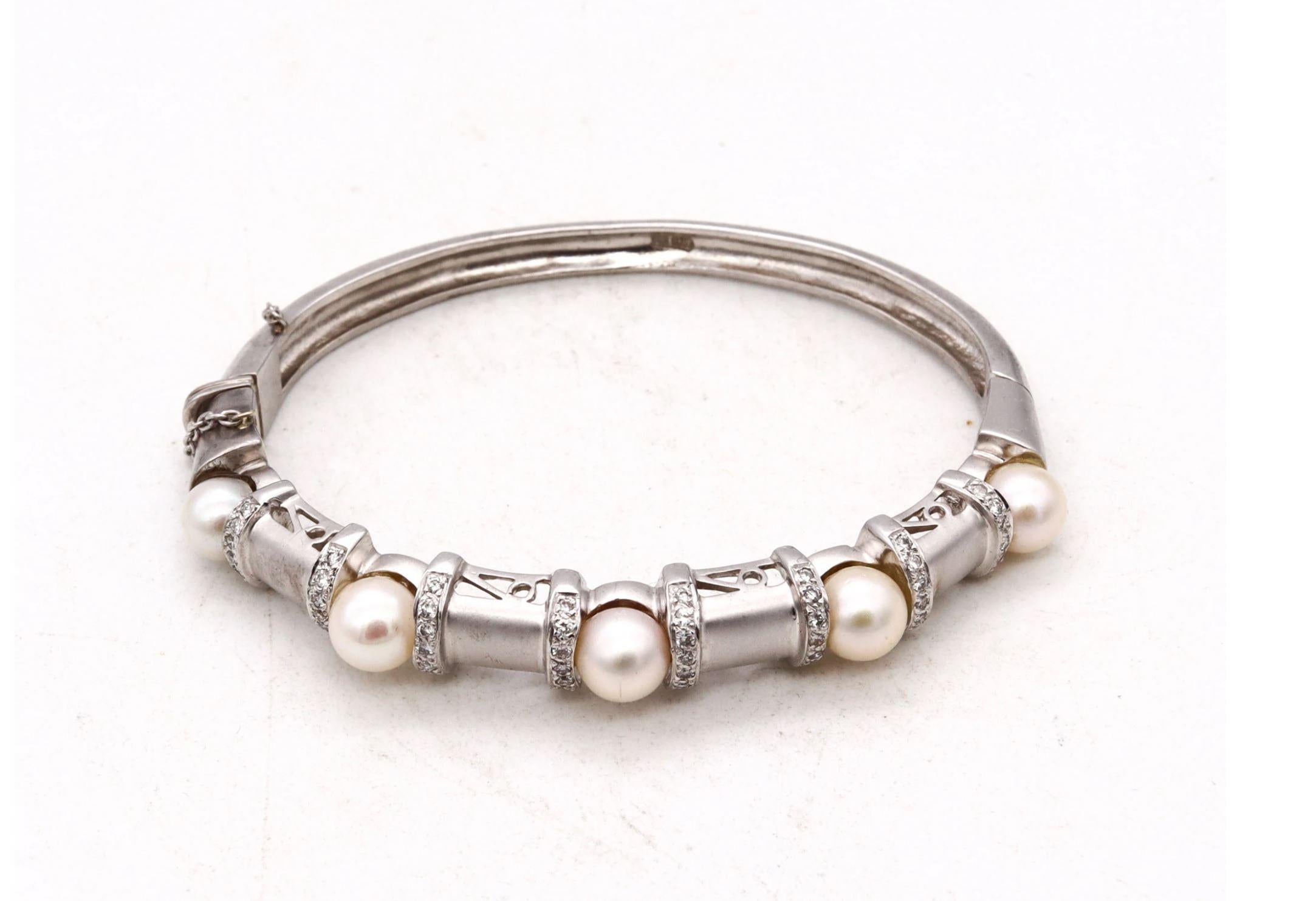 Jeweled bangle bracelet with Akoya Pearls.

A modern Italian piece, carefully crafted in solid white gold of 14 karats, with frosted satin finish. It is suited, with an invisible hinge with a boxed push lock for closure and a security