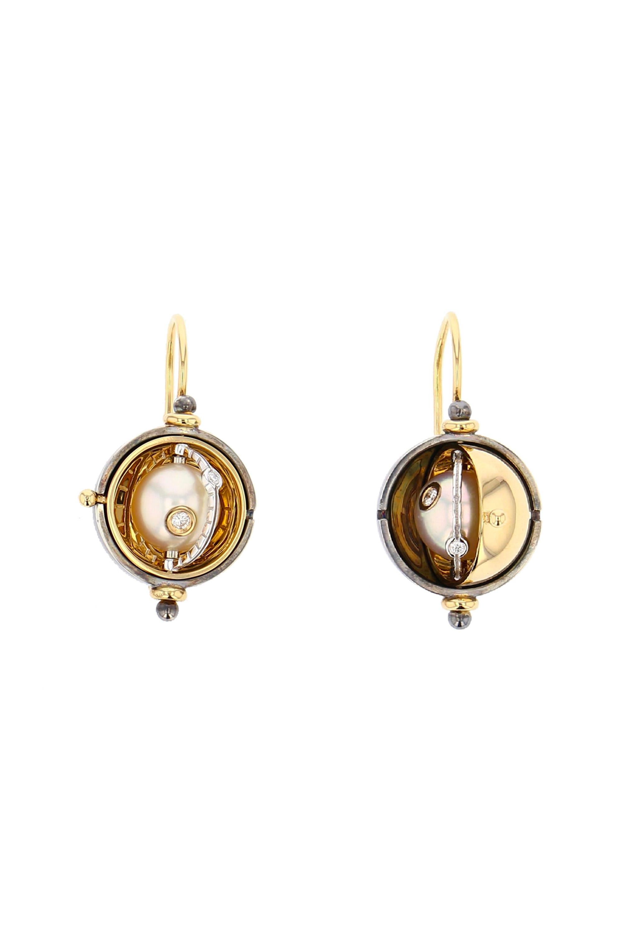 Gold and distressed silver earrings. Rotating sphere revealing an akoya pearl encircled by a white gold ring  set with a diamond.

Details:
Akoya pearls 
4 Diamonds: 0.09 cts
18k Yellow Gold: 12 g
Distressed Silver: 6 g
Made in France
