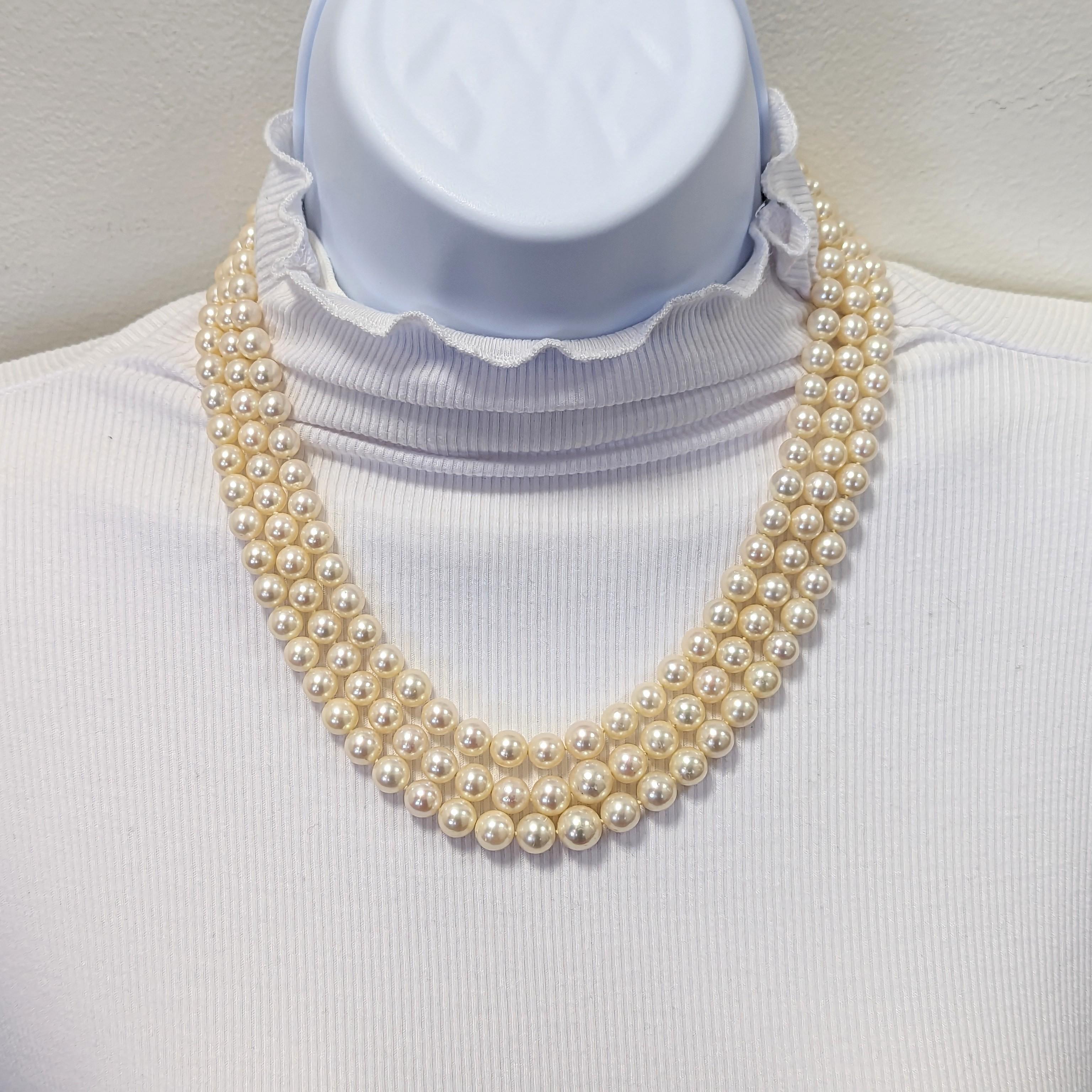 Beautiful white Akoya pearls size 7-8.5 mm each with a lovely clasp handmade in 14k yellow gold with white round Akoya pearls and carved emeralds, pink sapphire rounds, and blue sapphire rounds.  Three rows of natural Akoya round white pearls.
