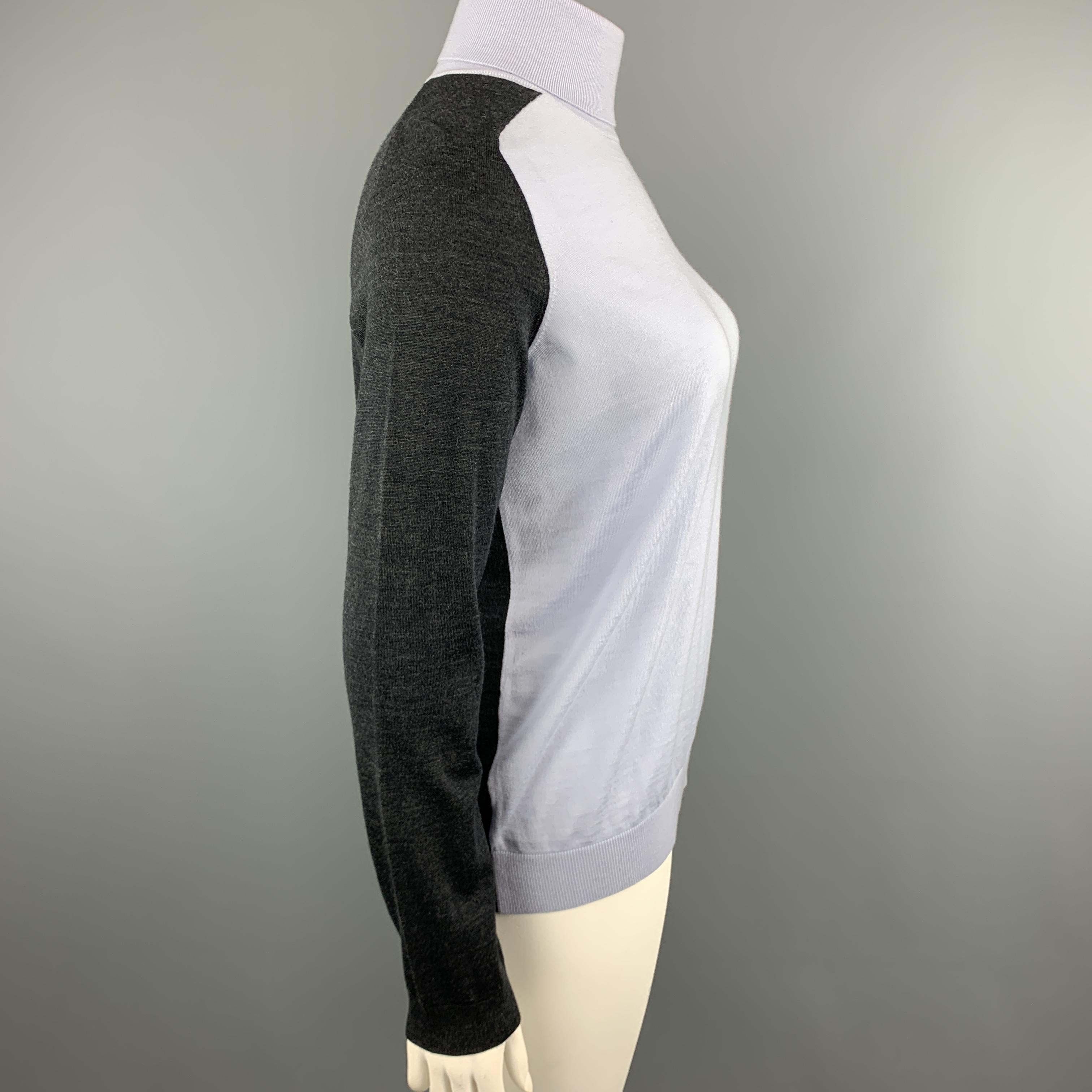 AKRIS turtleneck sweater comes in light blue wool knit with asymmetrical charocal panels. 

Excellent Pre-Owned Condition.
Marked: 12

Measurements:

Shoulder: 16 in.
Bust: 42 in.
Sleeve: 25 in.
Length:  26 in.