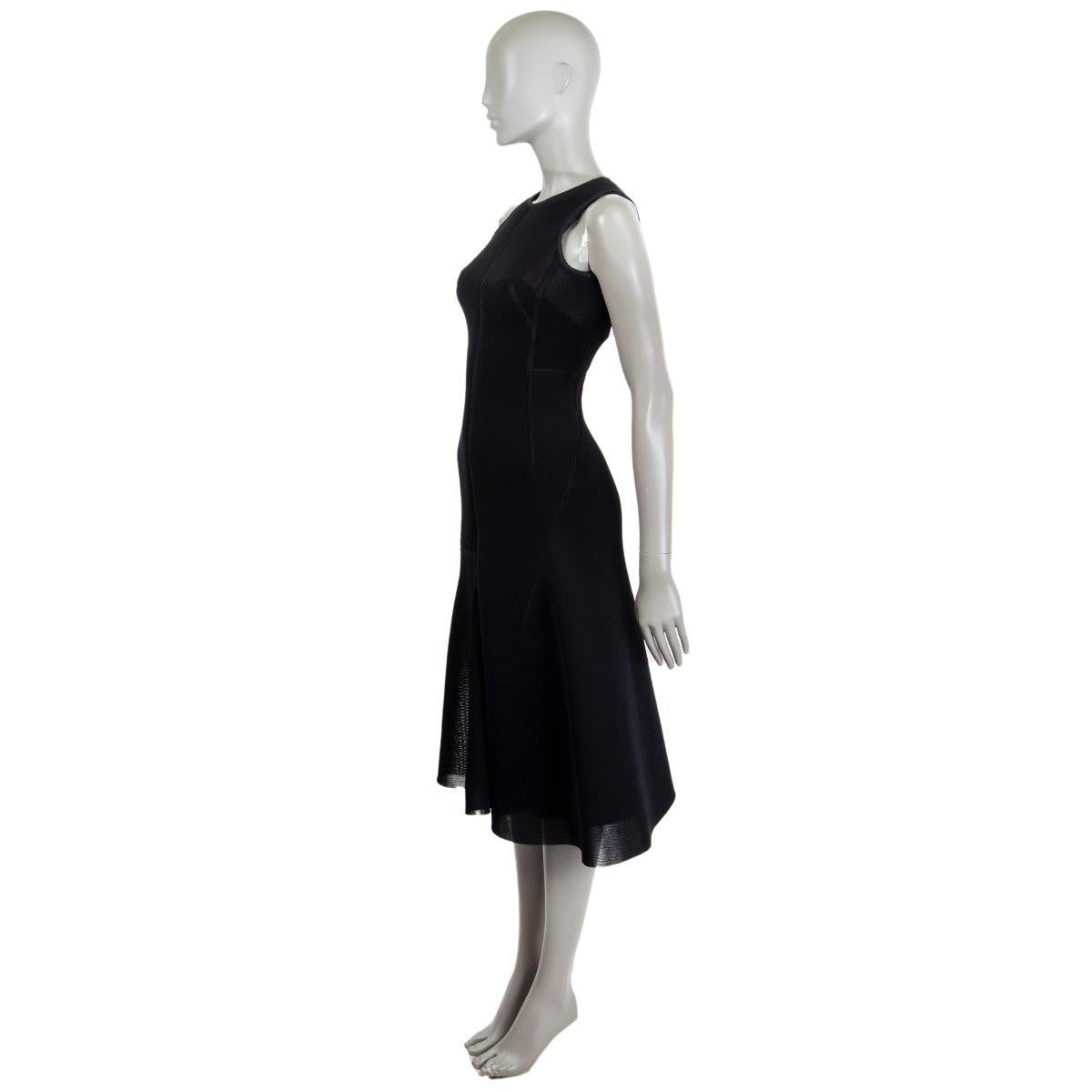 100% authentic Akris sleeveless flared bottom midi dress in black nylon (100%) with a round neck. Closes on the back with a concealed zipper. Dress is sheer. Comes with a slip in a black nylon blend (assumed as tag is missing). Has been worn and is