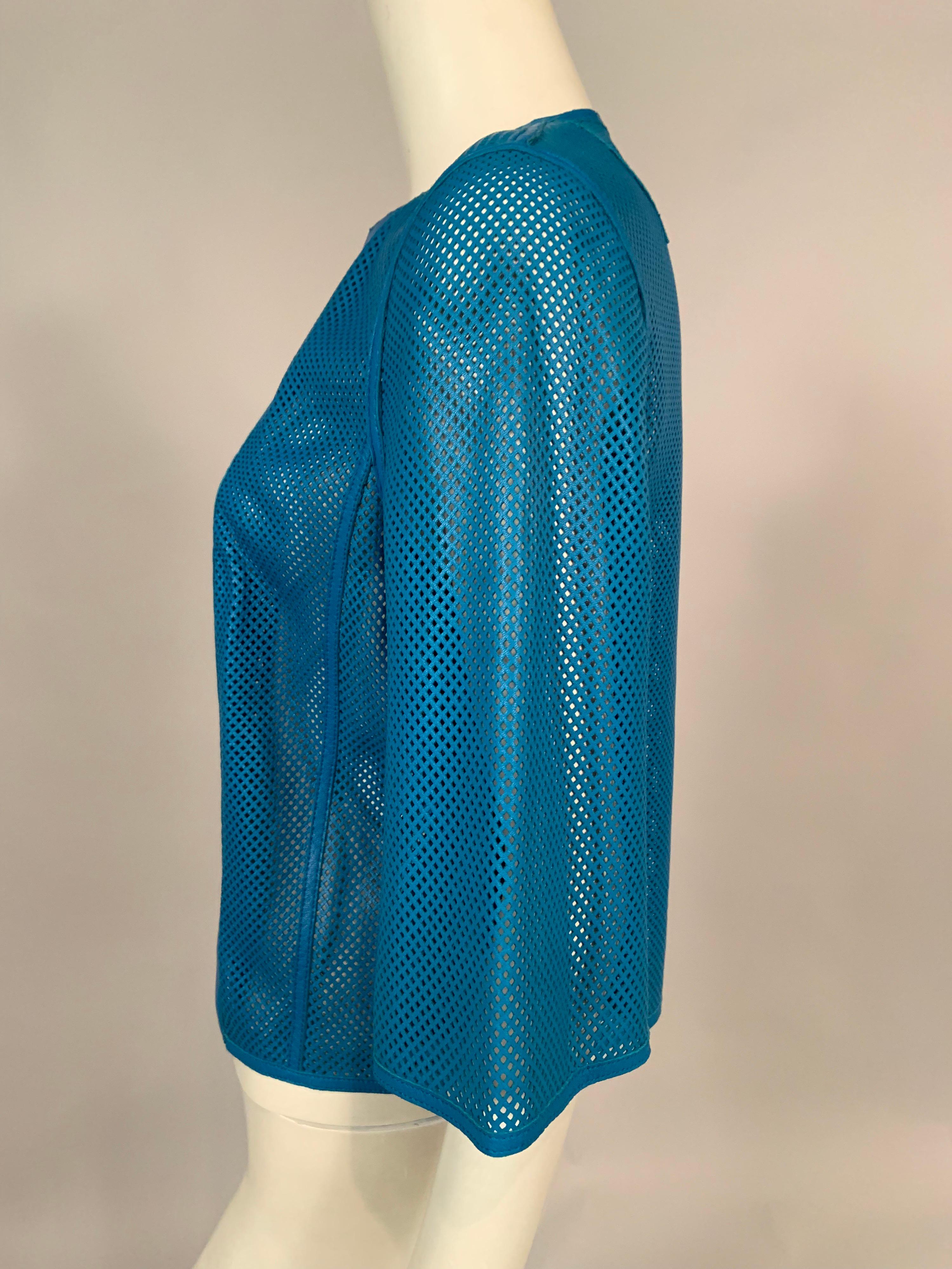 Akris buttery soft lambskin jacket in a gorgeous rich shade of blue is perforated tiny diamond shapes everywhere but the center front panels. It is so soft and light weight, and adds a great pop of color to any outfit. The jacket is in pristine