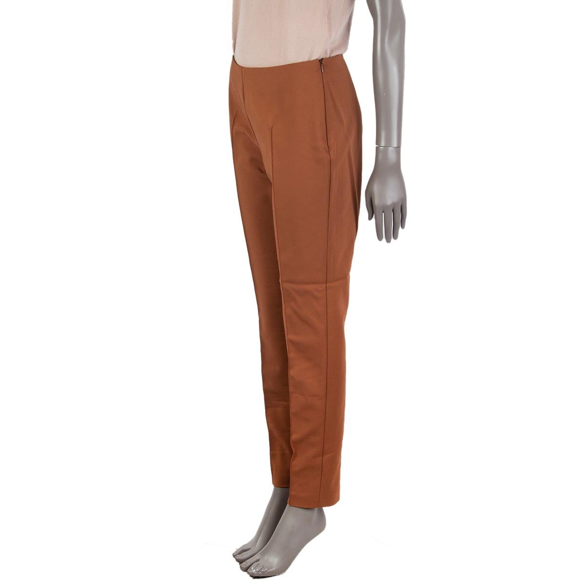 100% authentic AKRIS cigarette pants in cognac cotton (51%) polyamide (42%) elastane (7%)  with a stitched-front, mid-high waist. Unlined. Closes with a concealed zipper on the left side. Has been worn and is in excellent