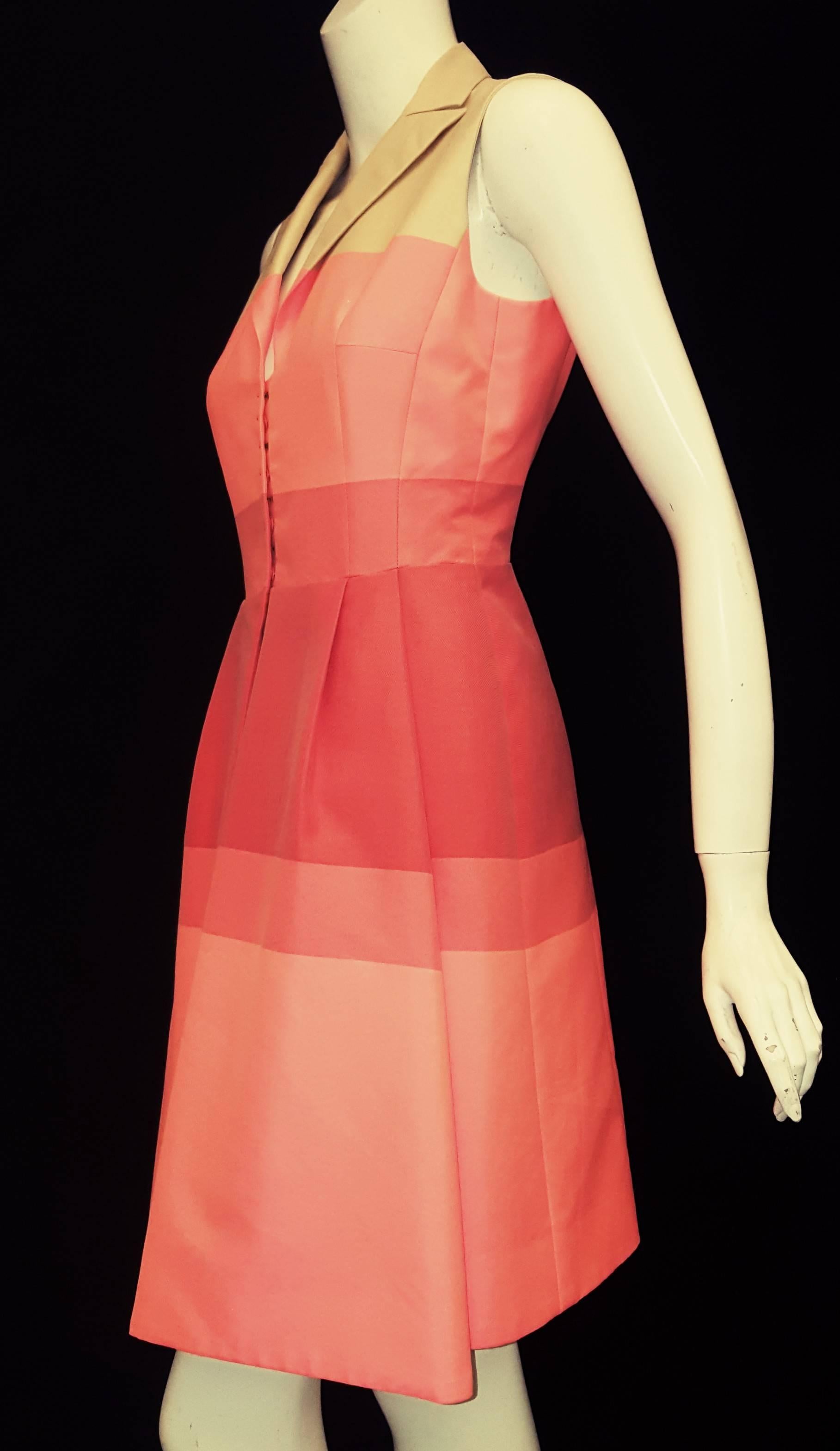 Akris coral hues and beige sleeveless dress with front opening hook and eye and snaps includes two slit pockets at the side.   The summery stripe cotton blend fabric in sunset coral tones dress has a tailored notch collar.  This garment contains,