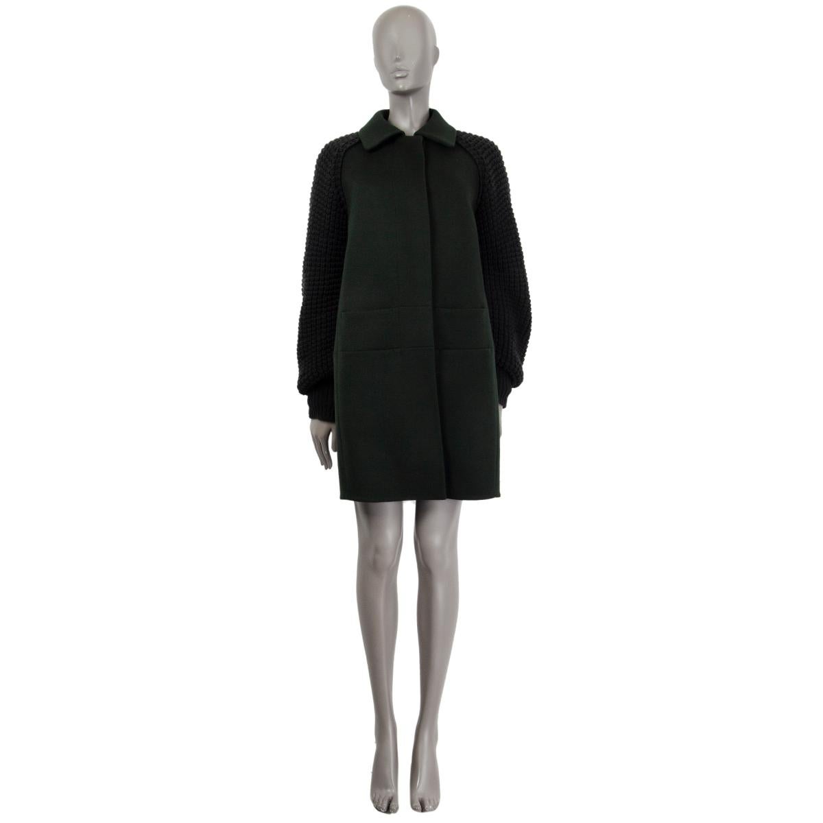 100% authentic AKRIS buttoned coat in forest green cashmere (100%) with knitted raglan sleeves. 4 slit pockets at front and hidden button closure. Lining of the sleeves is viscose (100%). Has been worn once and has a tiny month bite on the pocket. 