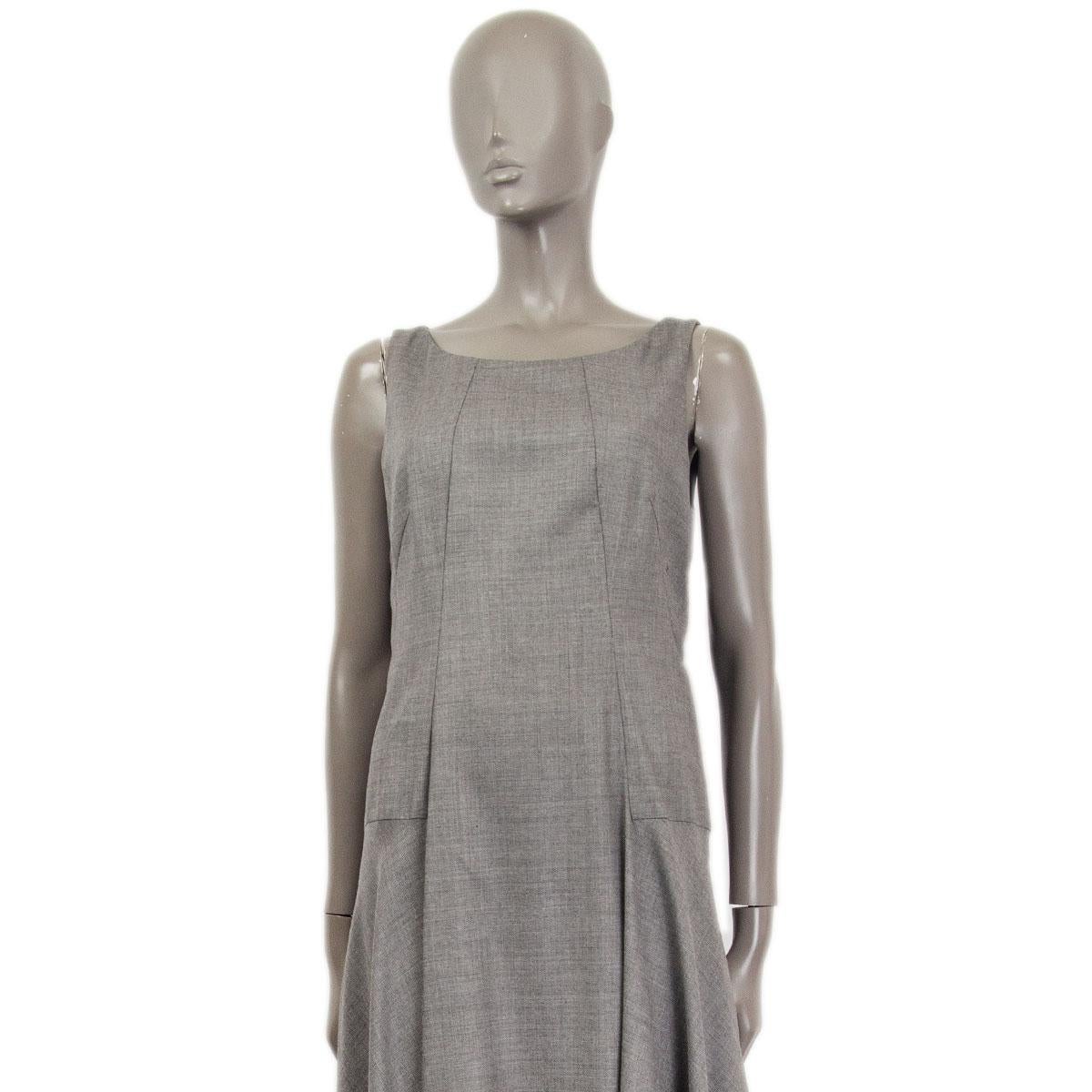 100% authentic Akris sleeveless midi dress in gray wool (100%) with with sharkbite hemline. Uniquely paneled with delicate tailoring. Closes on the back with a concealed zipper.  Lined in gray viscose (100%). Has been worn and is in excellent