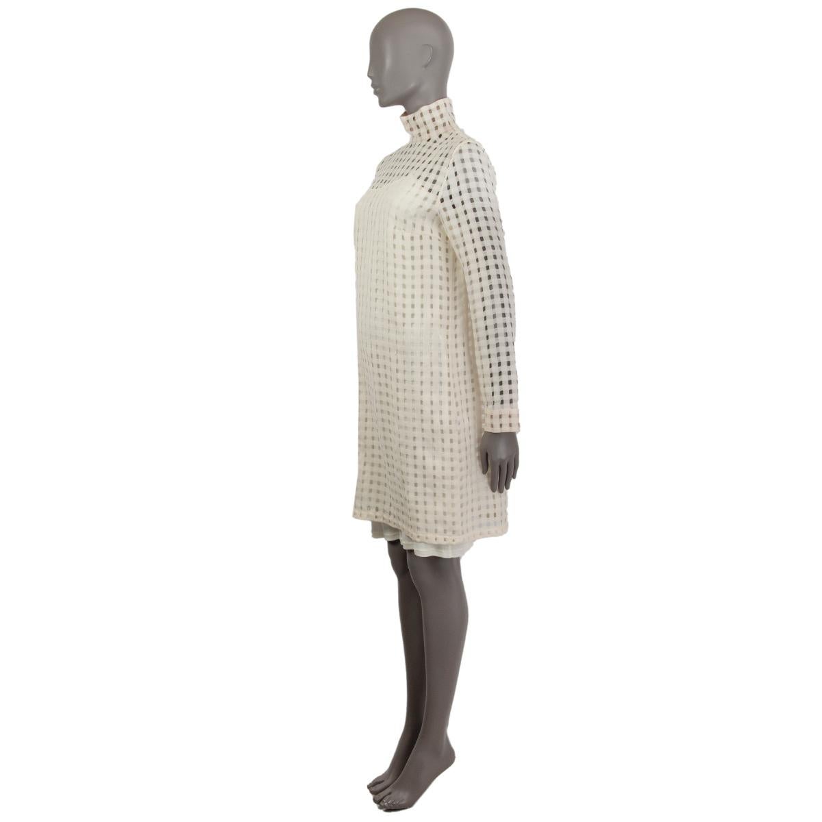 100% authentic Akris lattice-like stand-up collar long-sleeve gauze dress in off-white wool (100%). Opens with a concealed zipper on the back. Comes with slip dress undernetah in off-white viascose (100%). Brand new. 

Measurements
Tag