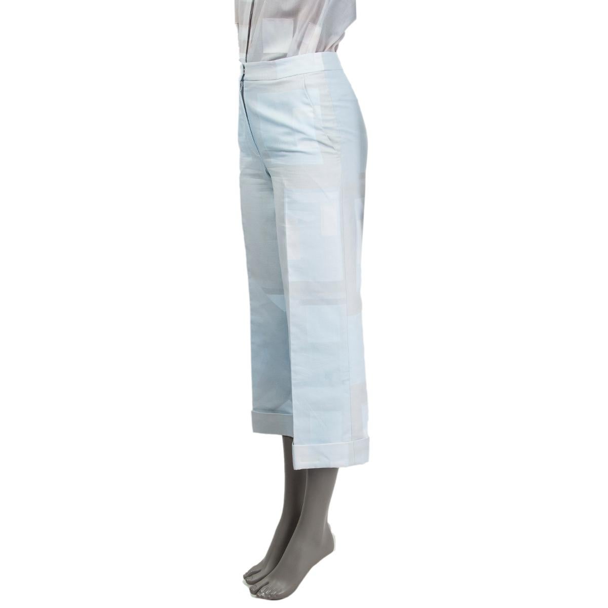 100% authentic Akris square print 3/4 cuffed pants in light blue, light grey and white cotton (100%) with slit pockets. Closes on the front with a concealed zipper and hook fastener. Partially lined in viscose (100%). Has been worn and is in