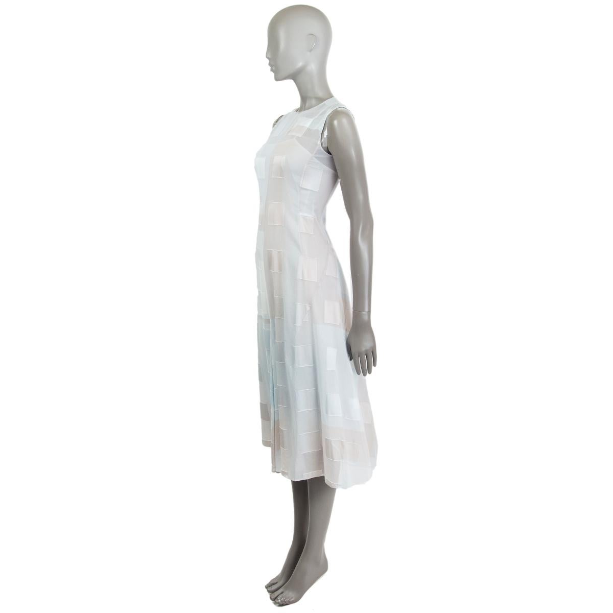 100% authentic Akris sleeveless sheer midi dress in light grey, inox, light blue and light taupe viscose (92%) and elastane (8%) with allover square details. Closes on the back with a concealed zipper. Comes with a slip in a light blue nylon blend