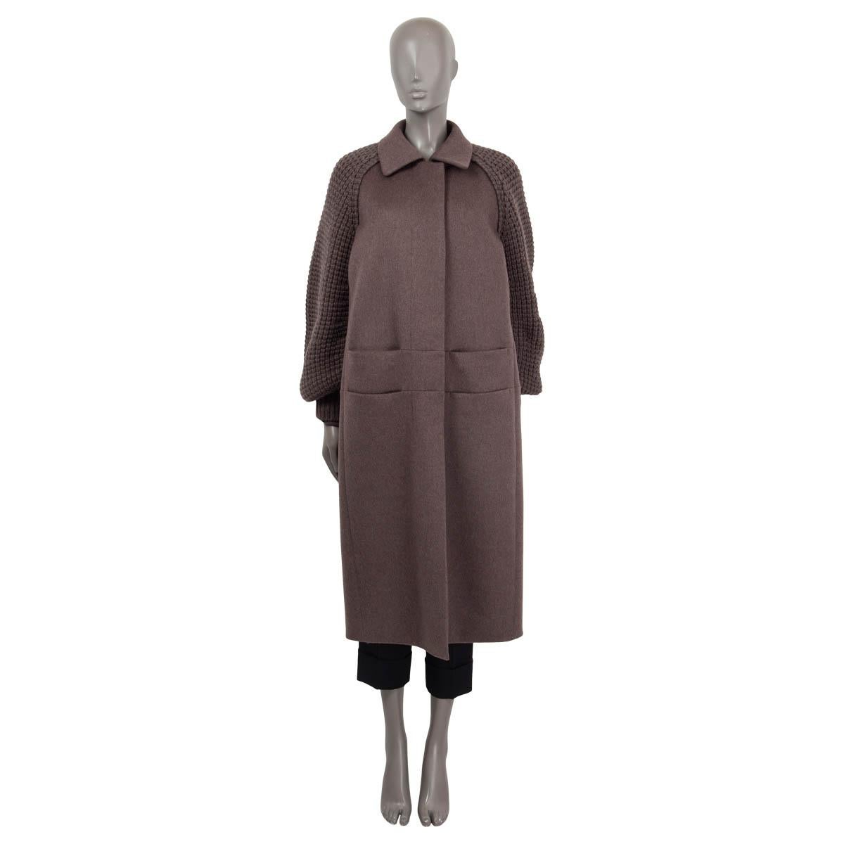 100% authentic Akris Marabella coat in sepia cashmere (100%). Features long chunky knit raglan sleeves (sleeve measurements taken from the neck) and four slit pockets on the front. Opens with concealed buttons on the front. Semi lined in sepia silk