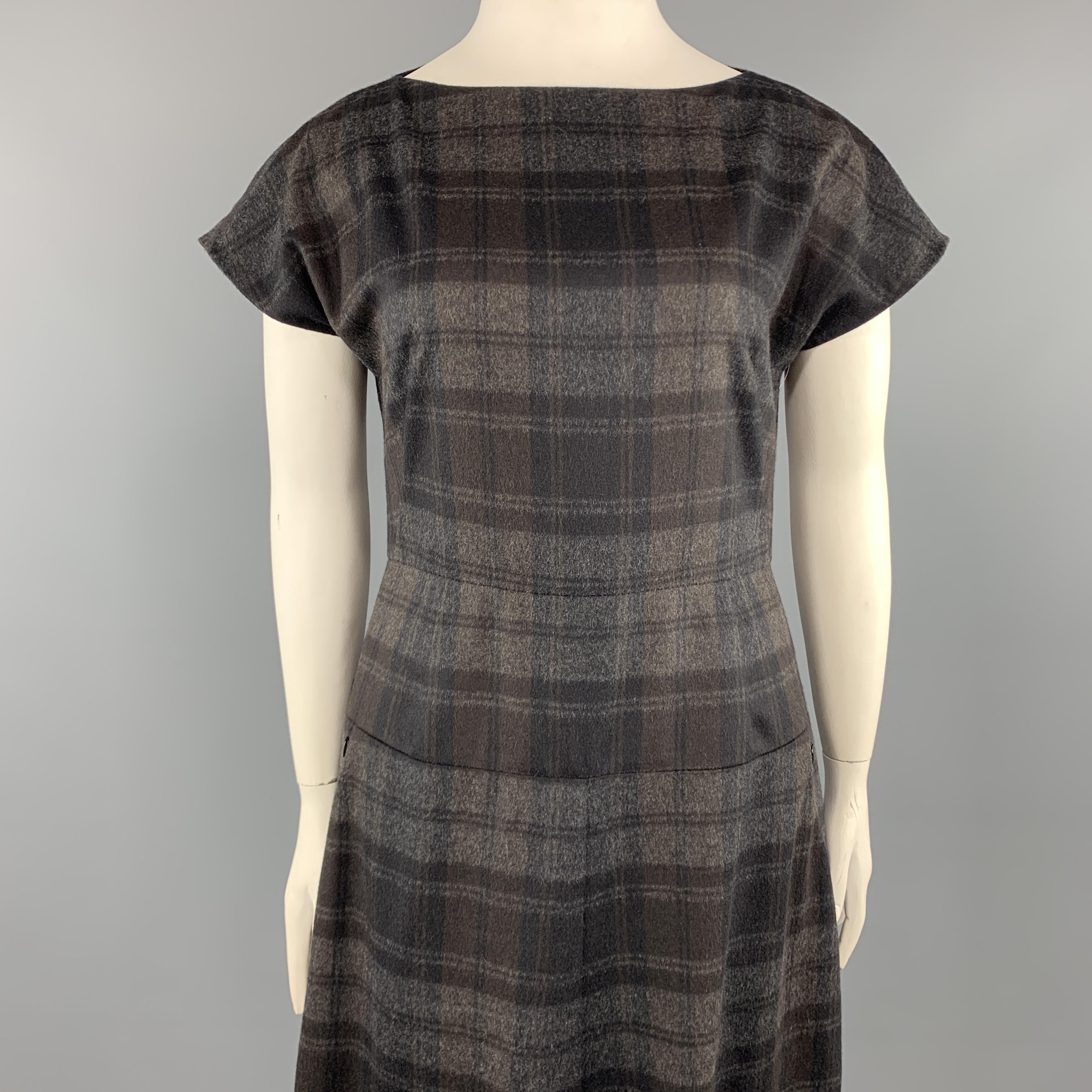 AKRIS shift dress comes in charcoal gray plaid wool angora blend fabric with a boat neck, cap sleeve, fitted waist panel with slanted zip pockets, and slit skirt. 

Excellent Pre-Owned Condition.
Marked: 10

Measurements:

l	Shoulder: 16 in.
l	Bust:
