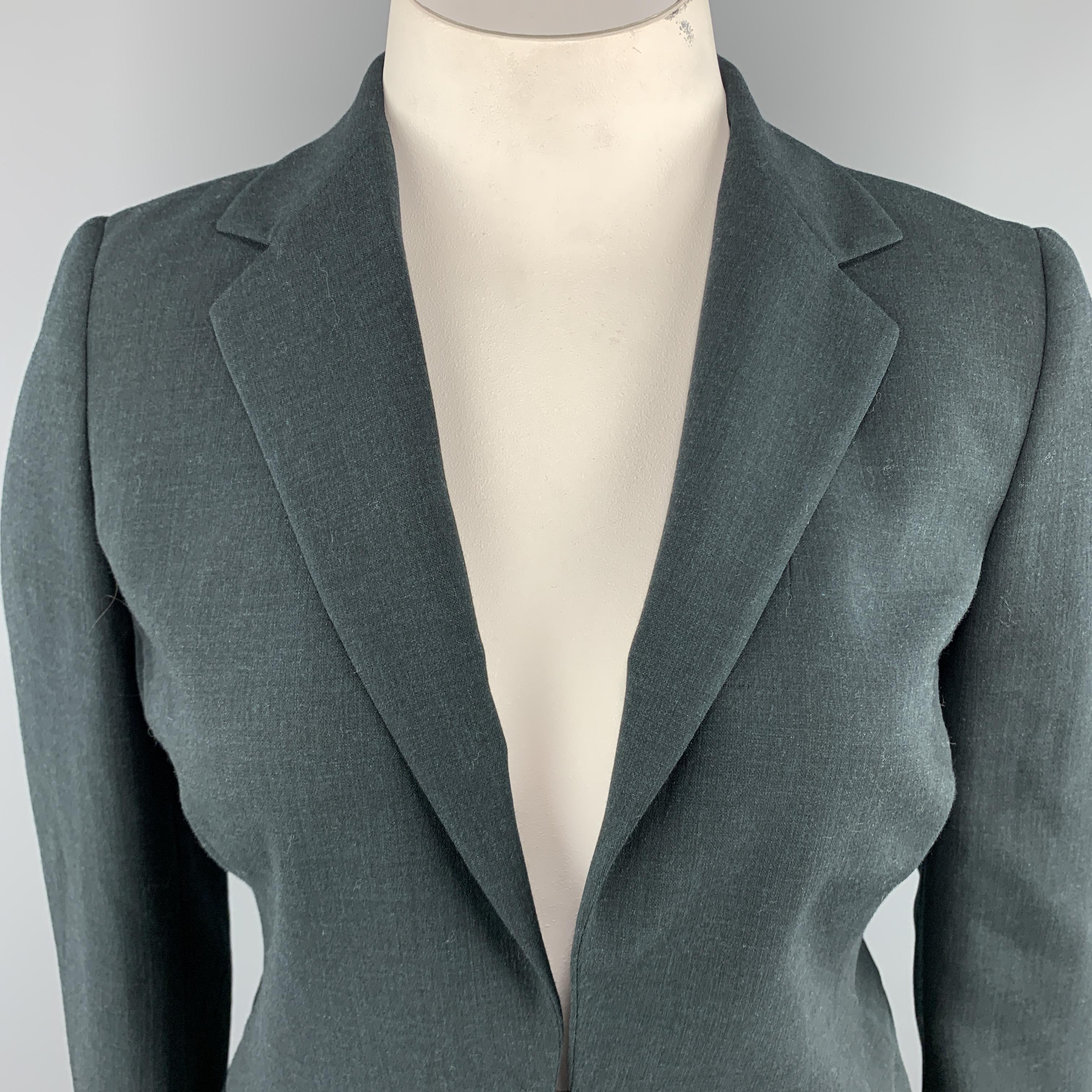 AKRIS blazer comes in forest green wool fabric and features a classic notch lapel, double hook eye closure, and detachable zip off panel with faux flap pockets. Made in Switzerland.

Excellent Pre-Owned Condition.
Marked: US
