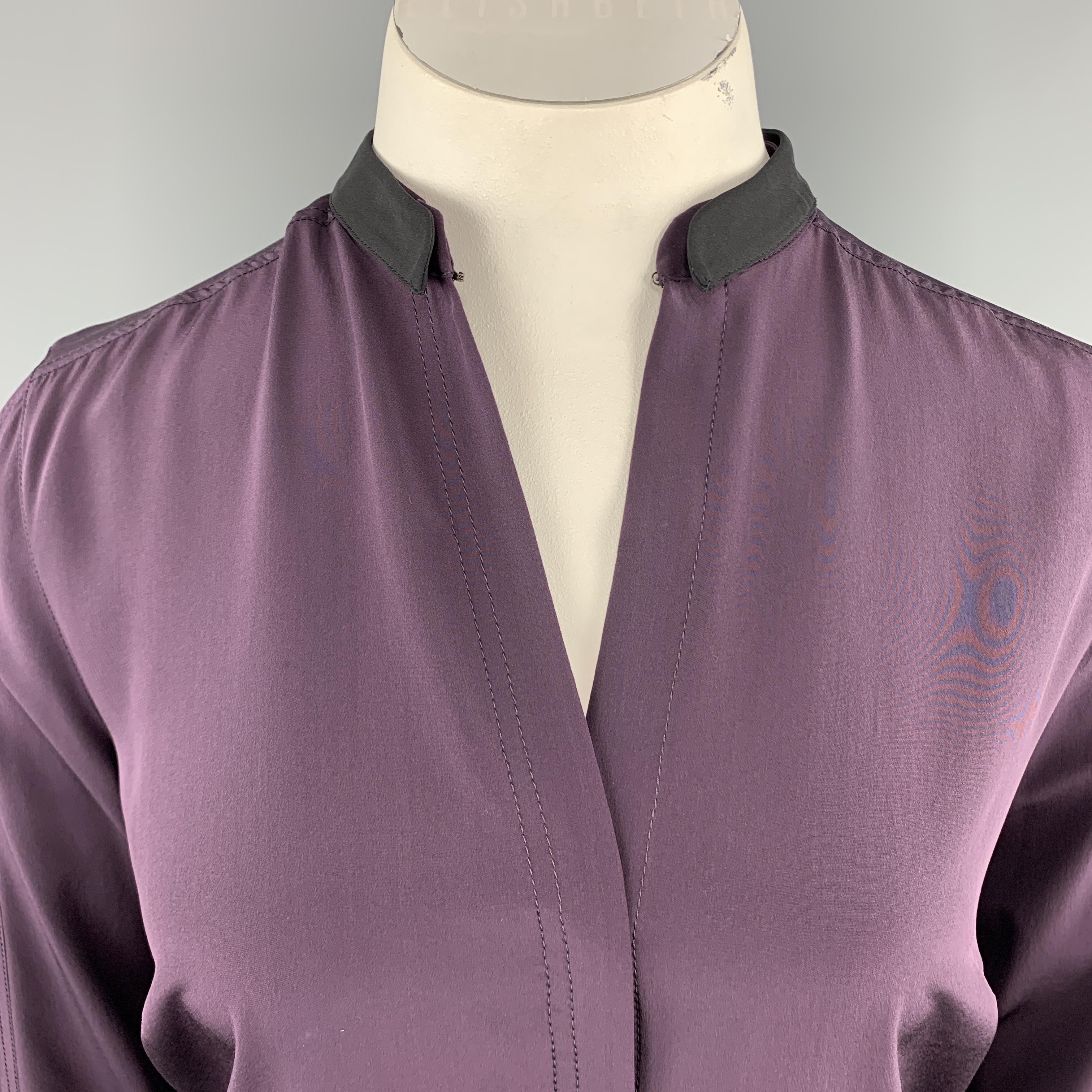 AKRIS blouse comes in plum purple silk with a hidden placket button up closure, detachable black band collar, and bi level hem. Wear it open as a V neck or use hook eye at collar t close. 

Excellent Pre-Owned Condition.
Marked: