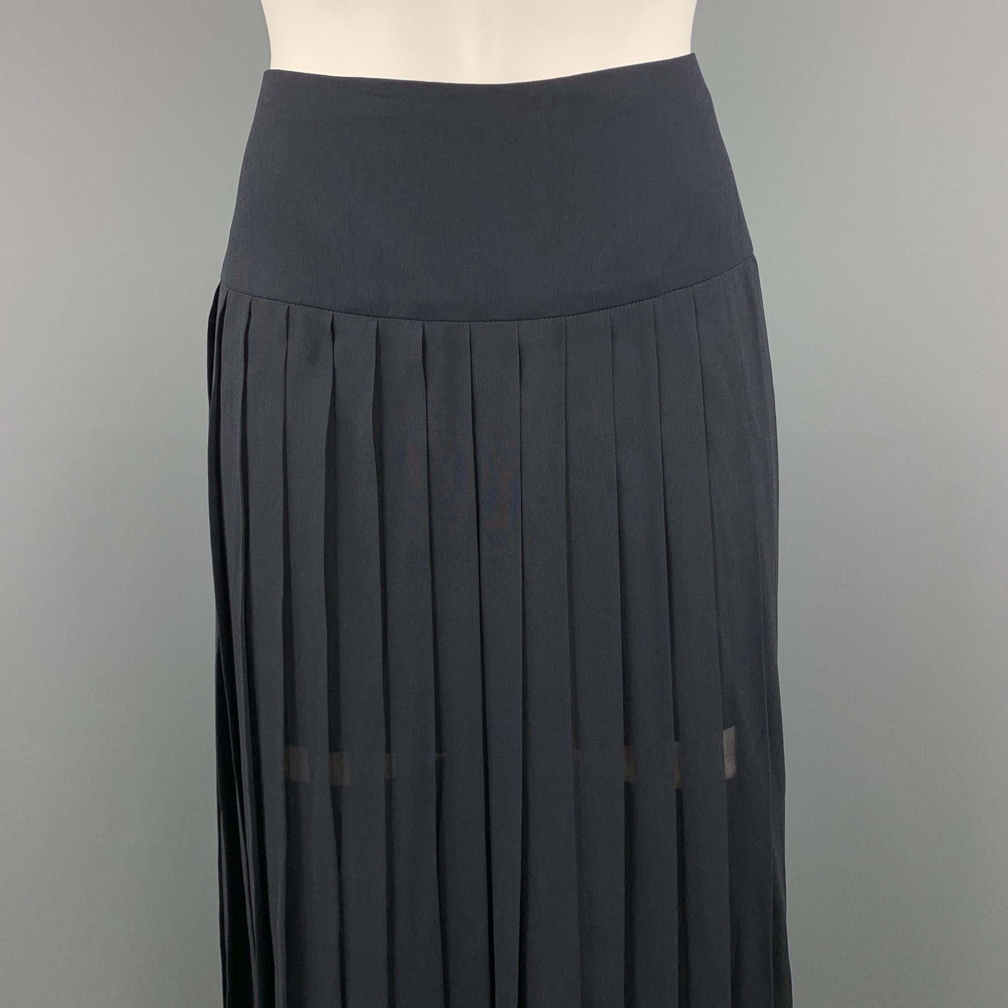AKRIS long line skirt comes in navy silk chiffon with a thick waistband and box pleating throughout. Made in Switzerland.

Excellent Pre-Owned Condition.
Marked: US 6

Measurements:

Waist: 30 in.
Hip: 40 in.
Length: 39 in.