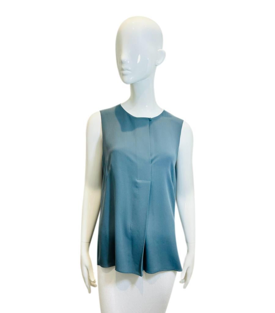Akris Sleeveless Silk Top

Slate grey blouse designed with buttoned round neckline.

Featuring straight cut and front yoke detail.

Size – 10US

Condition – Very Good

Composition – 100% Silk