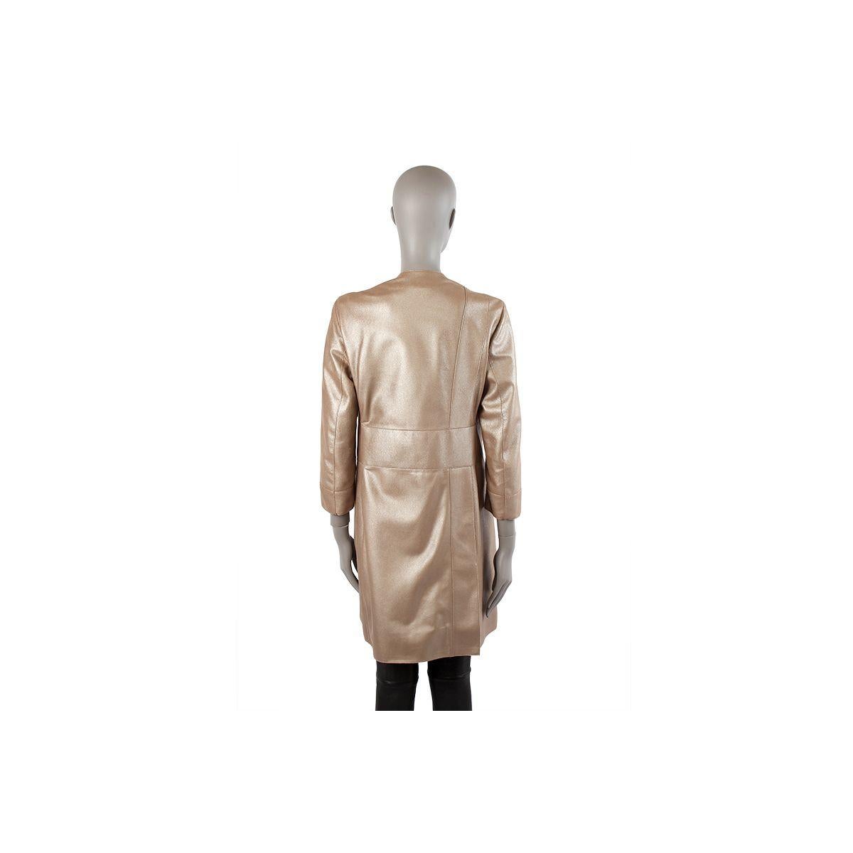100% authentic AKRIS between-seasons coat in metallic taupe leather. Two slit pockets on the front. Opens with two hidden buttons on the front. Lined in petrol iridescent viscose (55%) and acetate (45%). Has been worn and is in excellent