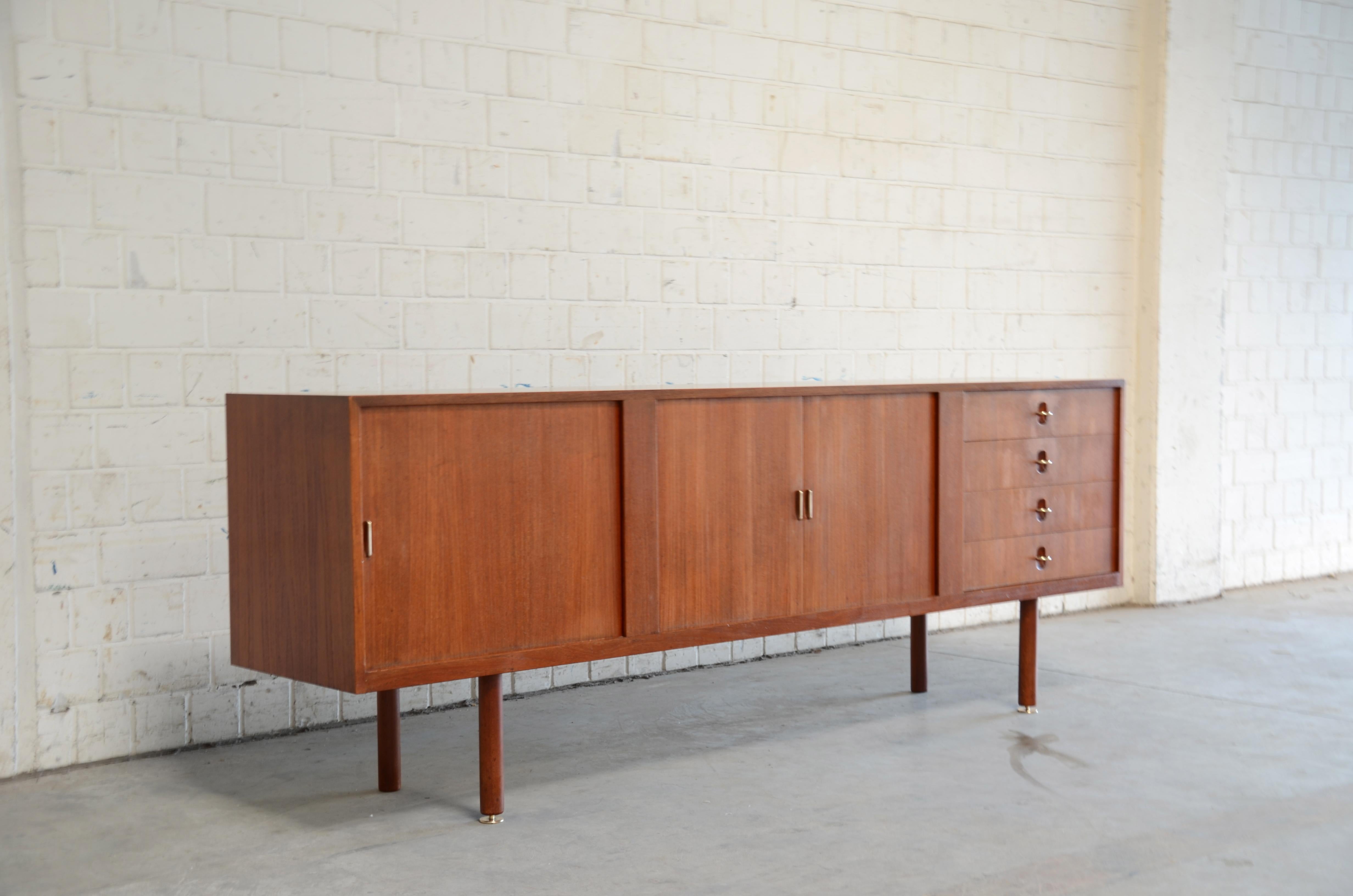 This Danish sideboard is one of the rarest you´ll find on the market.
Designed by Aksel Bender Madsen and Ejner Larsen and produced by Næstved Møbelfabrik in Denmark 1960s. Model NO 1708.
This sideboard is made of teak with simple disappearing