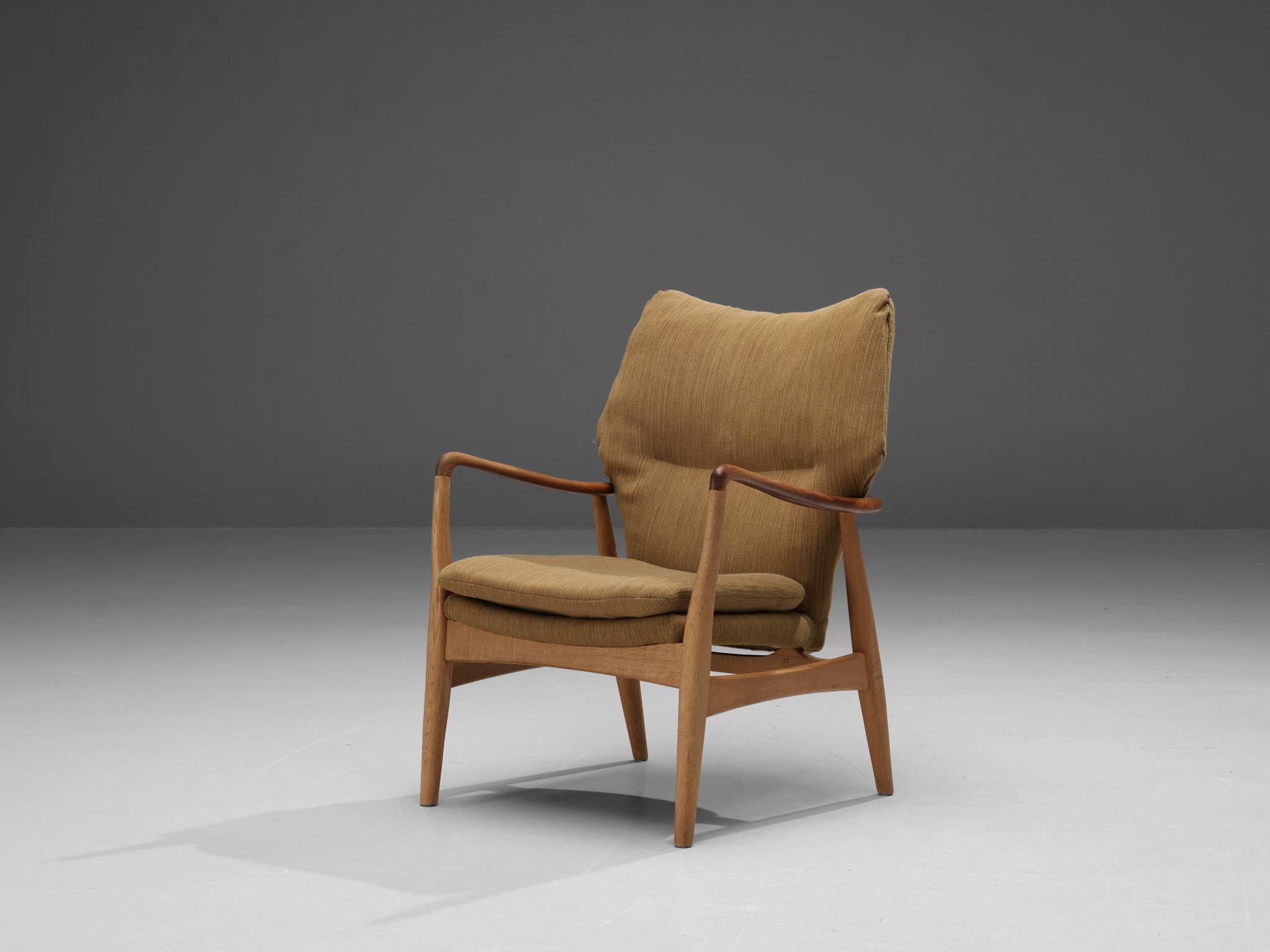 Aksel Bender Madsen for Bovenkamp, lounge chair, teak and oak, fabric, Denmark, 1950s.

Madsen is known for his modest, minimalist designs. This lounge chair has armrests made out of teak while the rest of the frame is oak. The frame has a