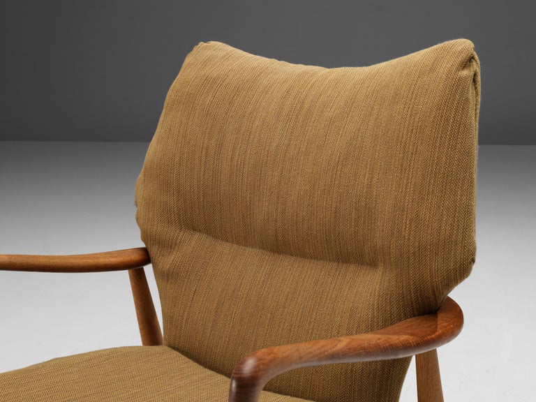 Aksel Bender Madsen for Bovenkamp, lounge chair, teak and oak, fabric, Denmark, 1950s.

Madsen is known for his modest, minimalist designs. This lounge chair has armrests made out of teak while the rest of the frame is oak. The frame has a