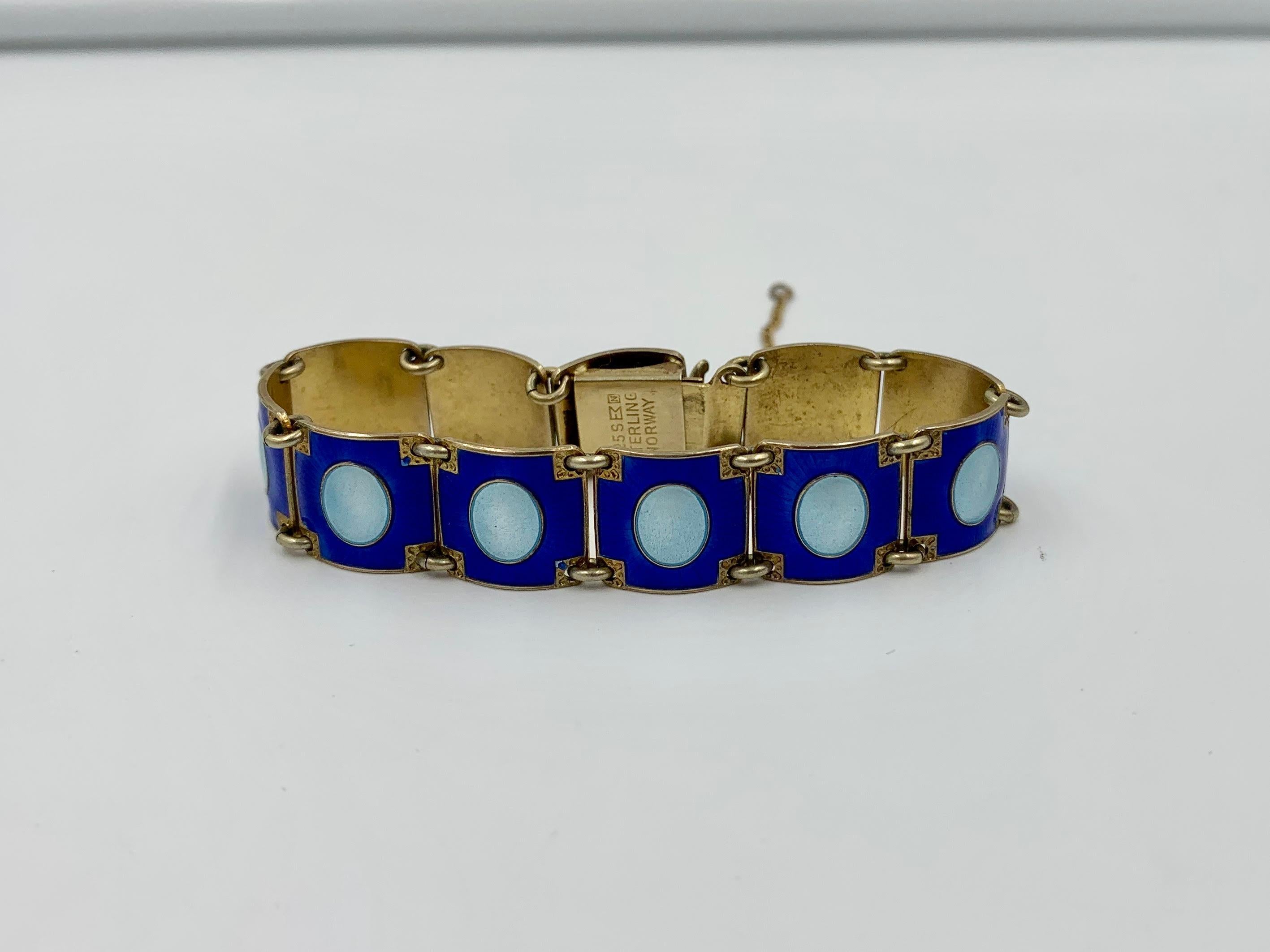 An exquisite Mid-Century Modern Eames Era period Bracelet by the esteemed Norwegian Silversmith Aksel Holmsen in an incredible blue and pale blue-green enamel design.  This bracelet is one of the most beautiful Scandinavian Enamel jewels we have