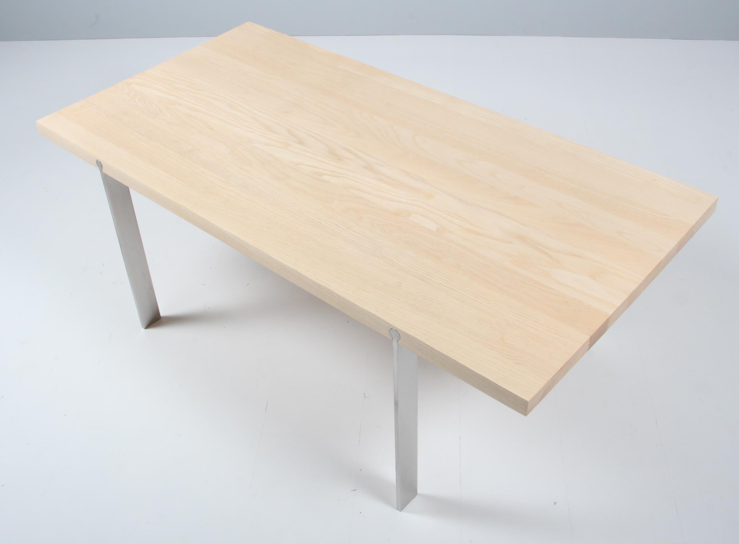 Aksel Kjersgaard coffee table in solid soap treated ash. Base of stainless steel.

Made by Naver.