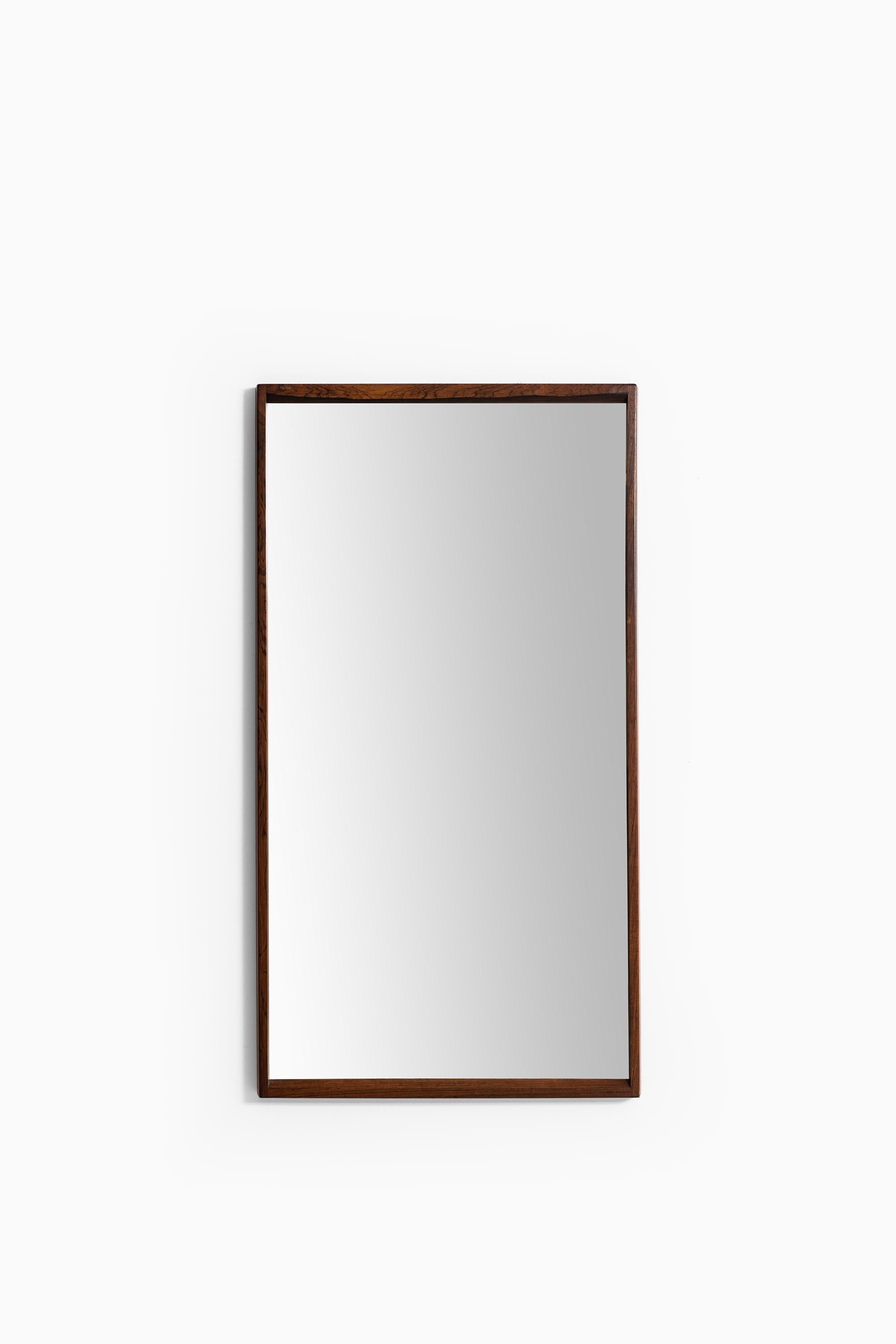 Mirror in rosewood designed by Aksel Kjersgaard. Produced by Odder in Denmark.
