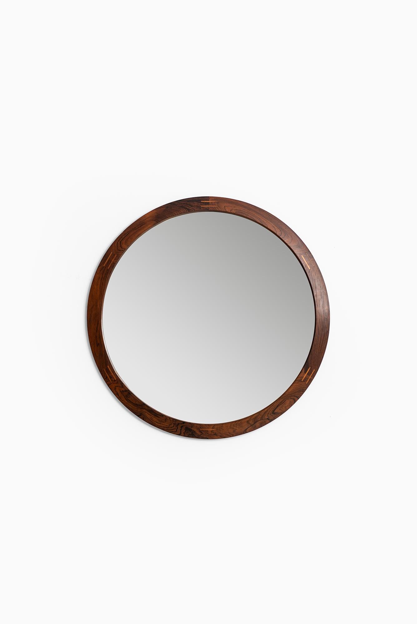Rare round mirror in rosewood designed by Aksel Kjersgaard. Produced by Odder in Denmark.