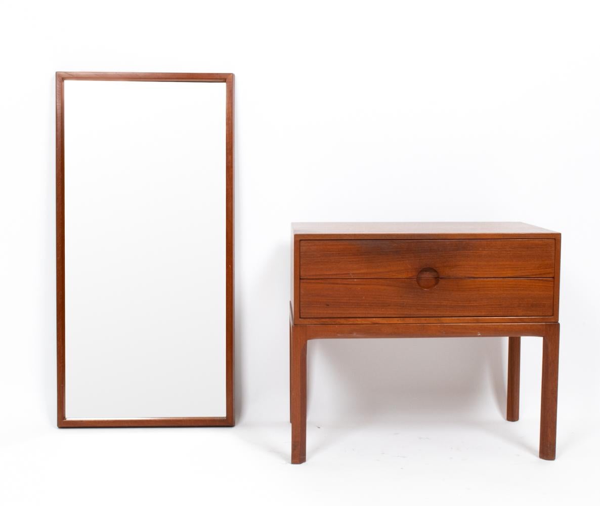 A beautiful Danish mid-century petite chest console and matching mirror designed by Aksel Kjersgaard, perfect for a hall or entry way. This charming set in teak shows fine craftsmanship, with dovetailed drawer joints.

Dimensions provided are for