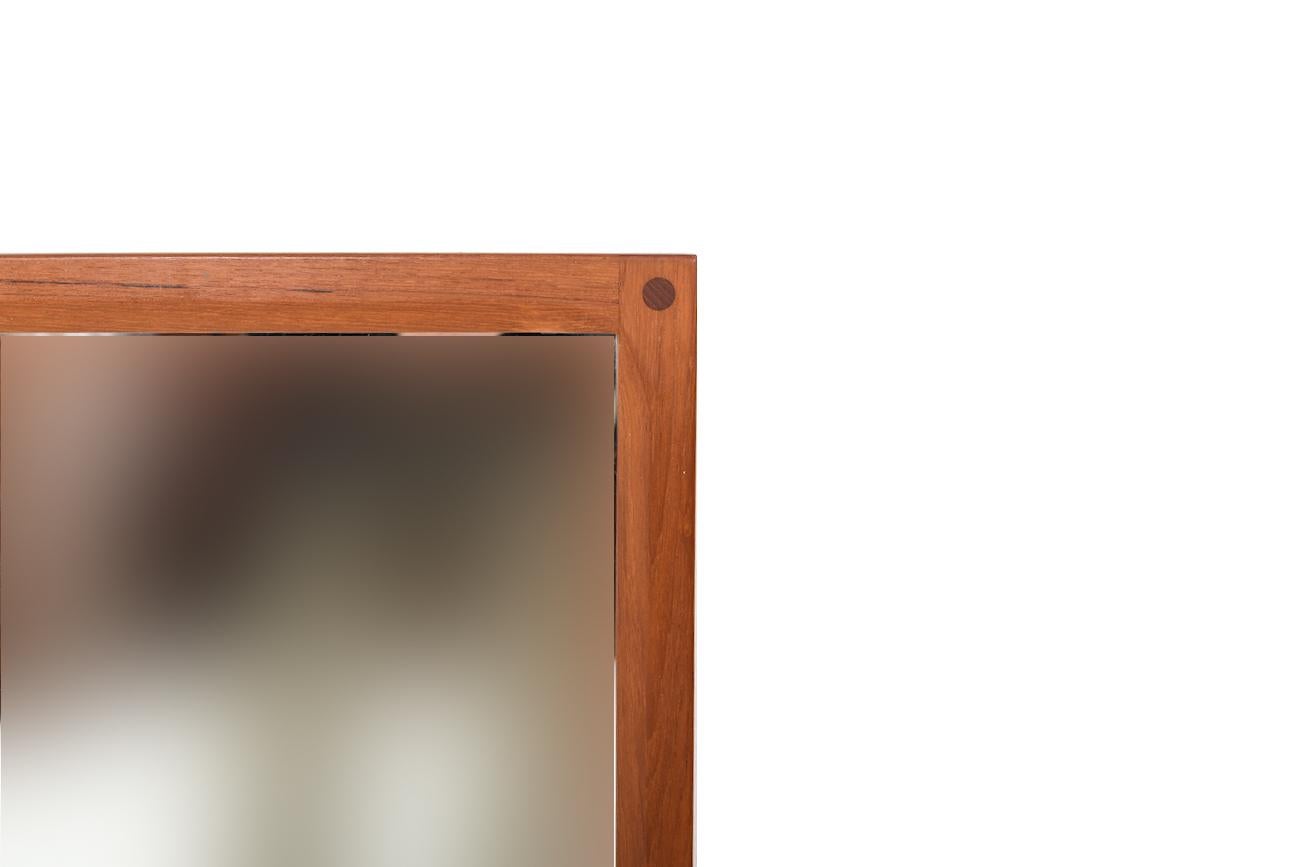 Danish teak wooden wall mirror. Design by Aksel Kjersgaard. Manufactured by Aksel Kjersgaard Odder, 1960s.