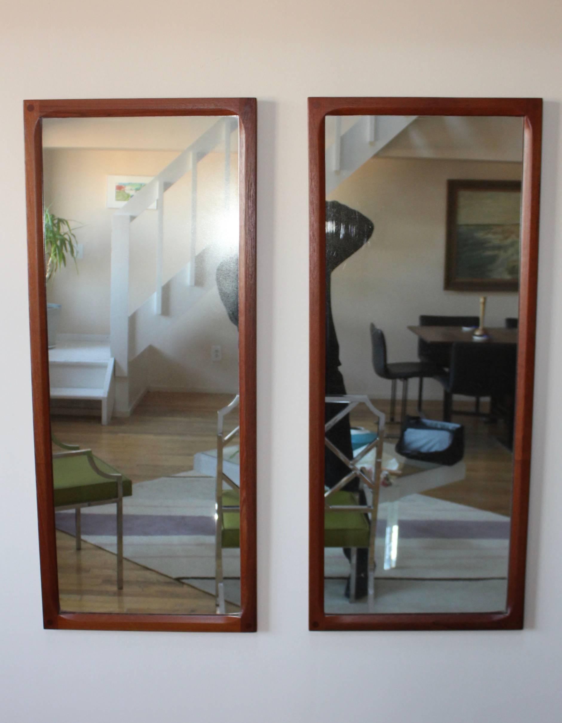 1960s solid teak pair of mirrors designed by Aksel Kjersgaard for Odder, lightly refinished.