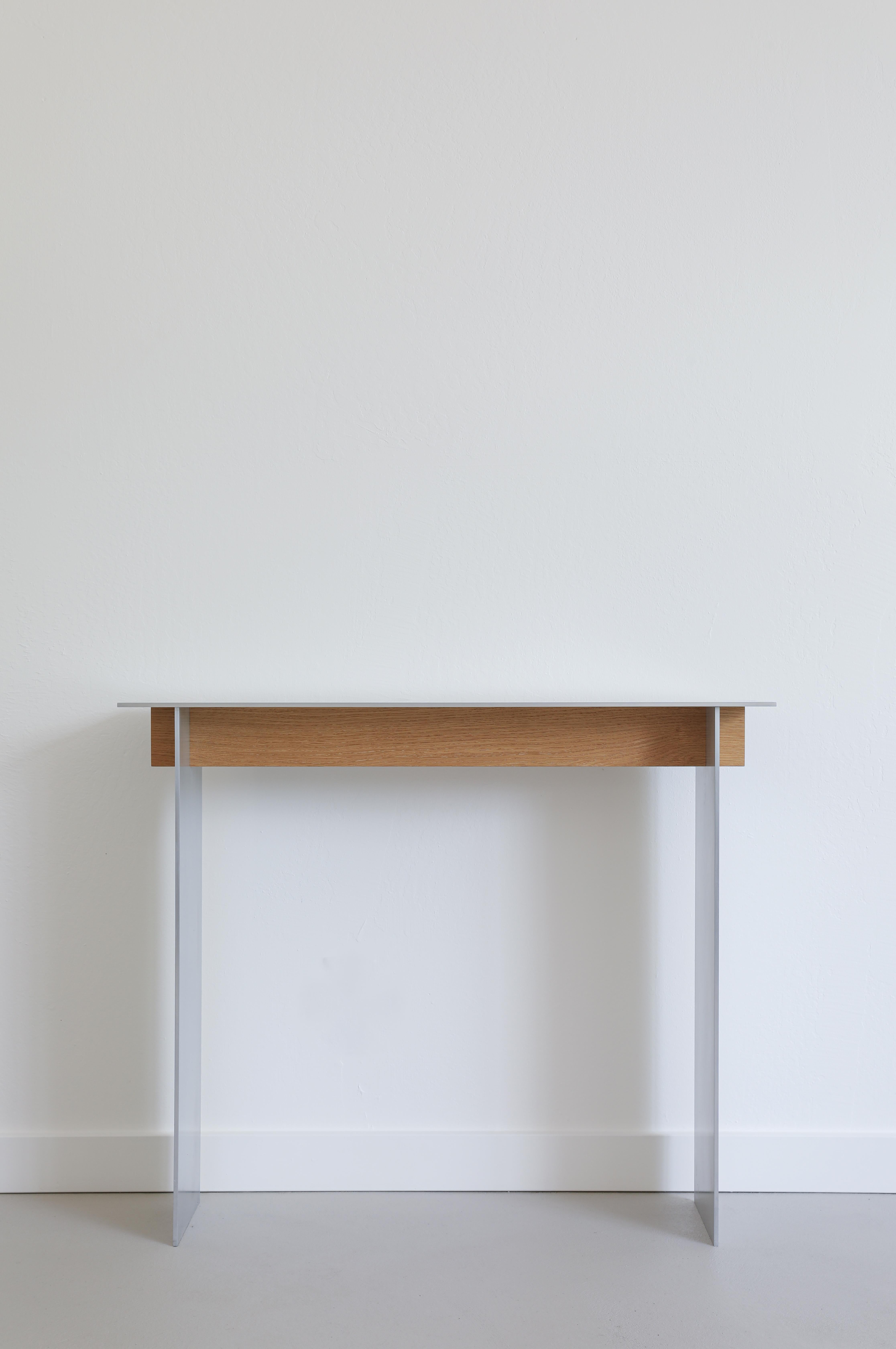 AL-02 Console Table by Orlando Pippig
Dimensions: W 92 x D 31 x H 81 cm (Dimensions may vary slightly)
Materials: Aluminum, White Oak

AL-02 is the continued study into aluminum’s deeply layered characteristics. A physical and visual interaction of