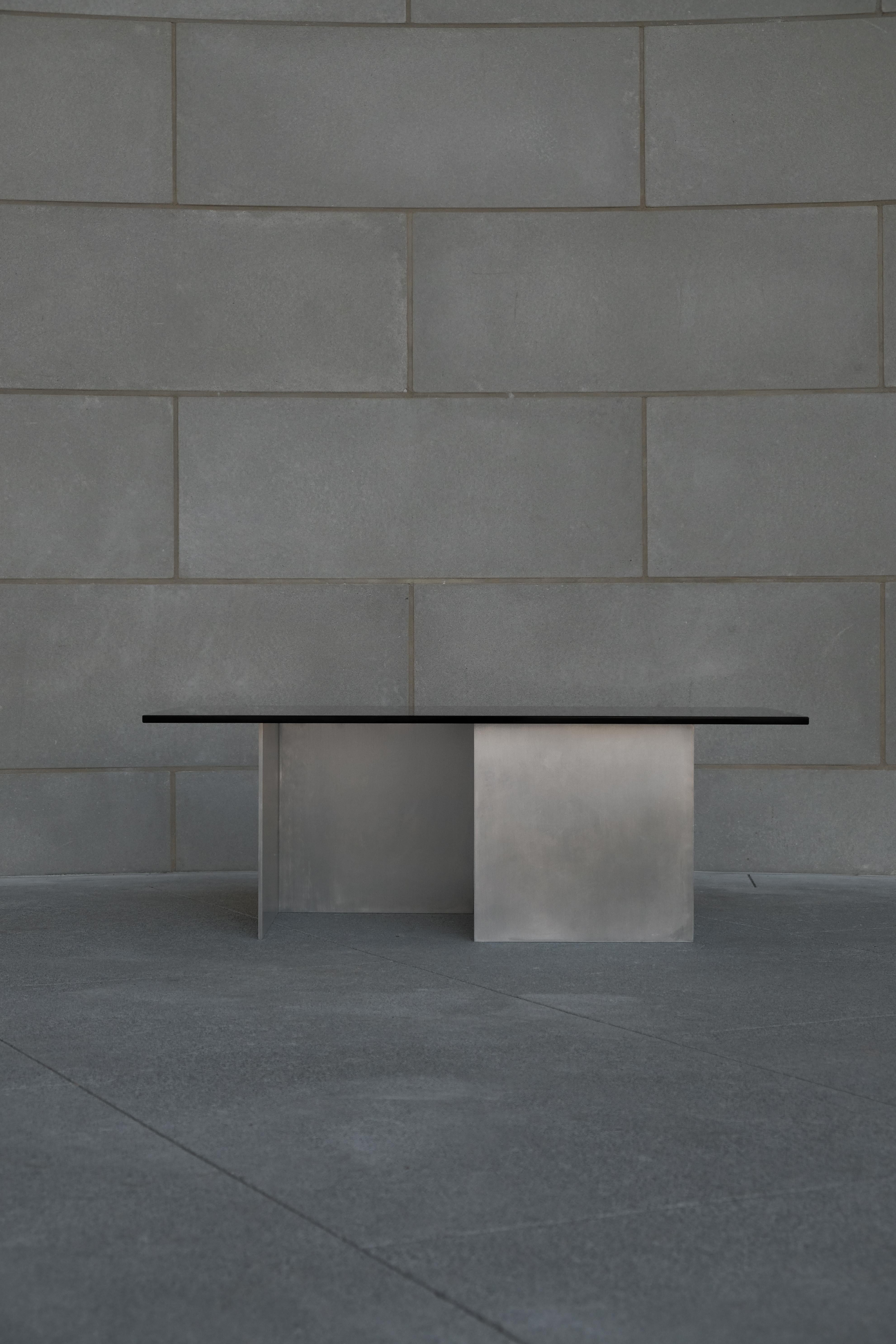 AL-03 Coffee Table by Orlando Pippig
Dimensions: W 102 x D 51 x H 36 cm (Dimensions may vary slightly)
Materials: Aluminum, Smoked Glass

The forms presented in AL-03 were heavily influenced by the glass artworks Larry Bell created in the 60’s, as