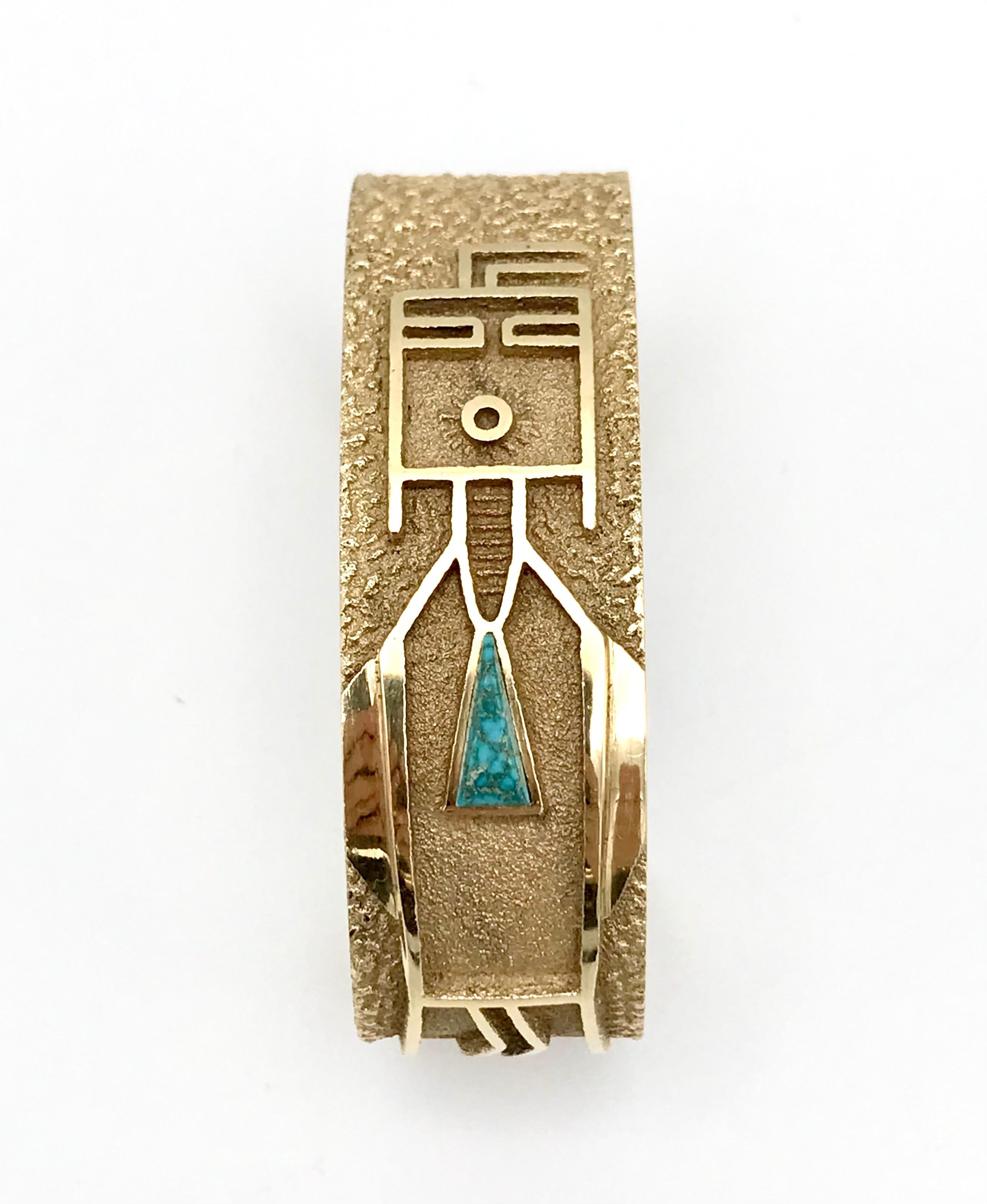14k yellow gold tufa cast cuff bracelet by Navajo jewelry artist Al Nez. Features high quality turquoise. 
Stamped with Al Nez maker's mark and a hallmark for 14k gold. 
Measurements: inner circumference is 5 1/4