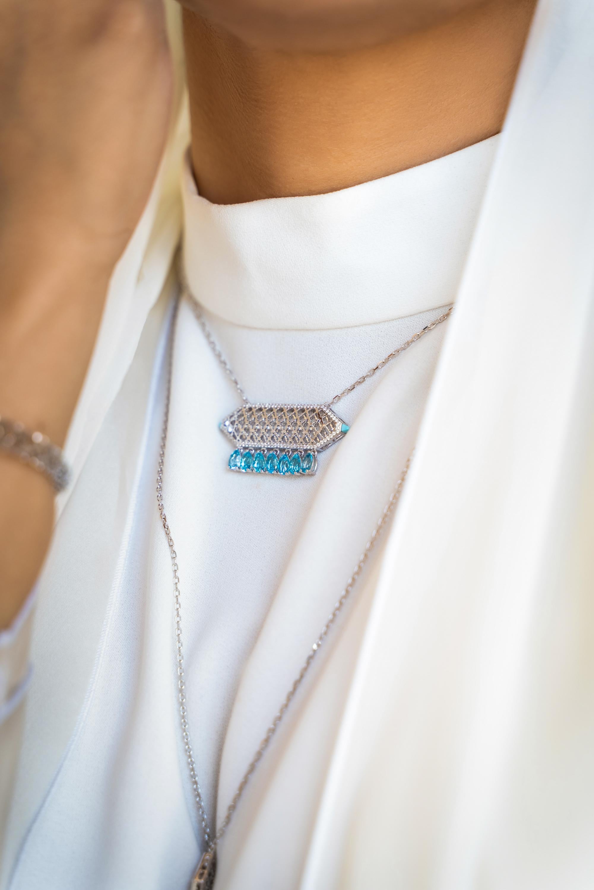 Necklace inspired by the Traditional Emirati Gold Jewellery, an intricate rectangular shape being completed by a delicate gemstone framed by a border set in brilliant cut diamonds and hanging aquamarine.

Chain in rope style with adjustable sliding