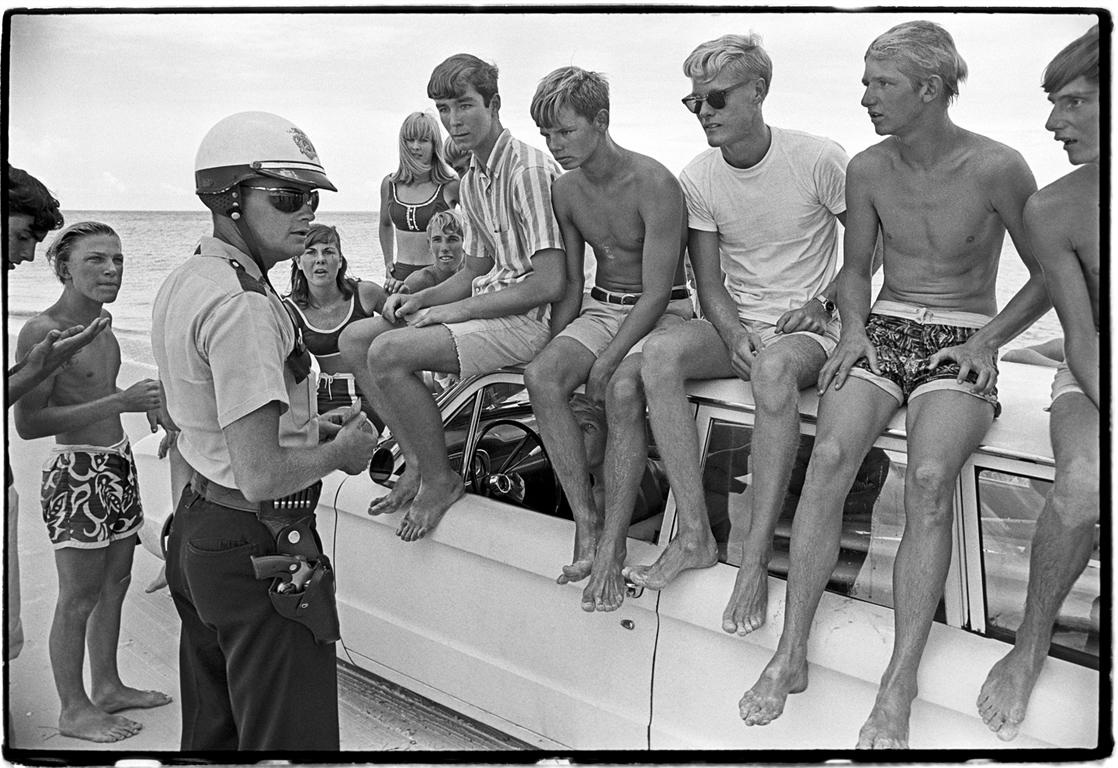Al Satterwhite Black and White Photograph - Surfers Kids and Cop