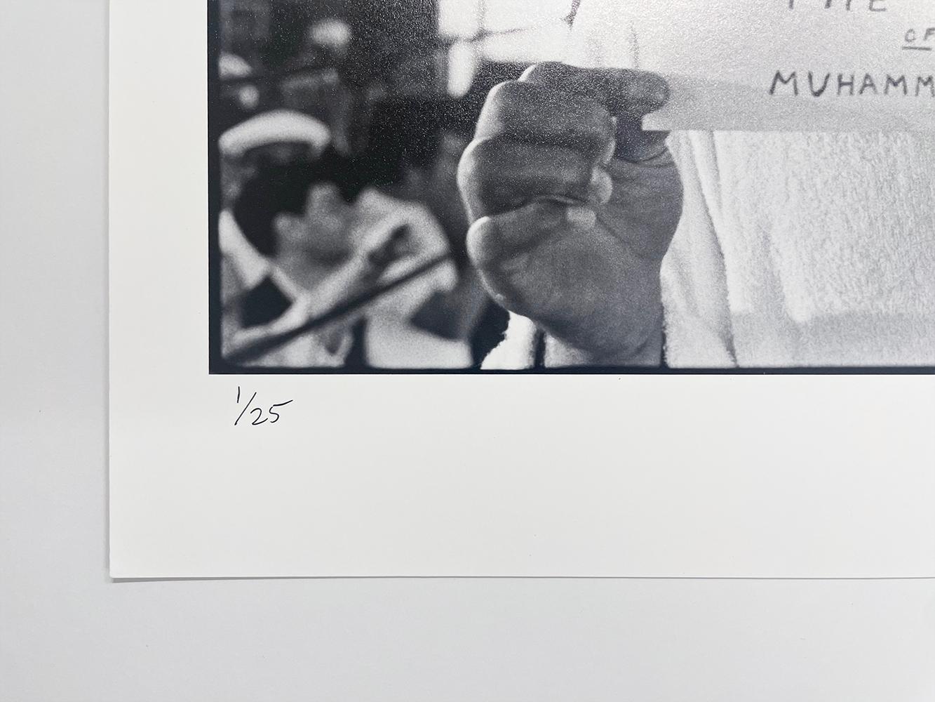 The Secret of Muhammad Ali von Al Satterwhite ist ein Schwarz-Weiß-Foto des Profiboxers Muhammad Ali in limitierter Auflage. Ali hält einen Umschlag mit der Aufschrift 