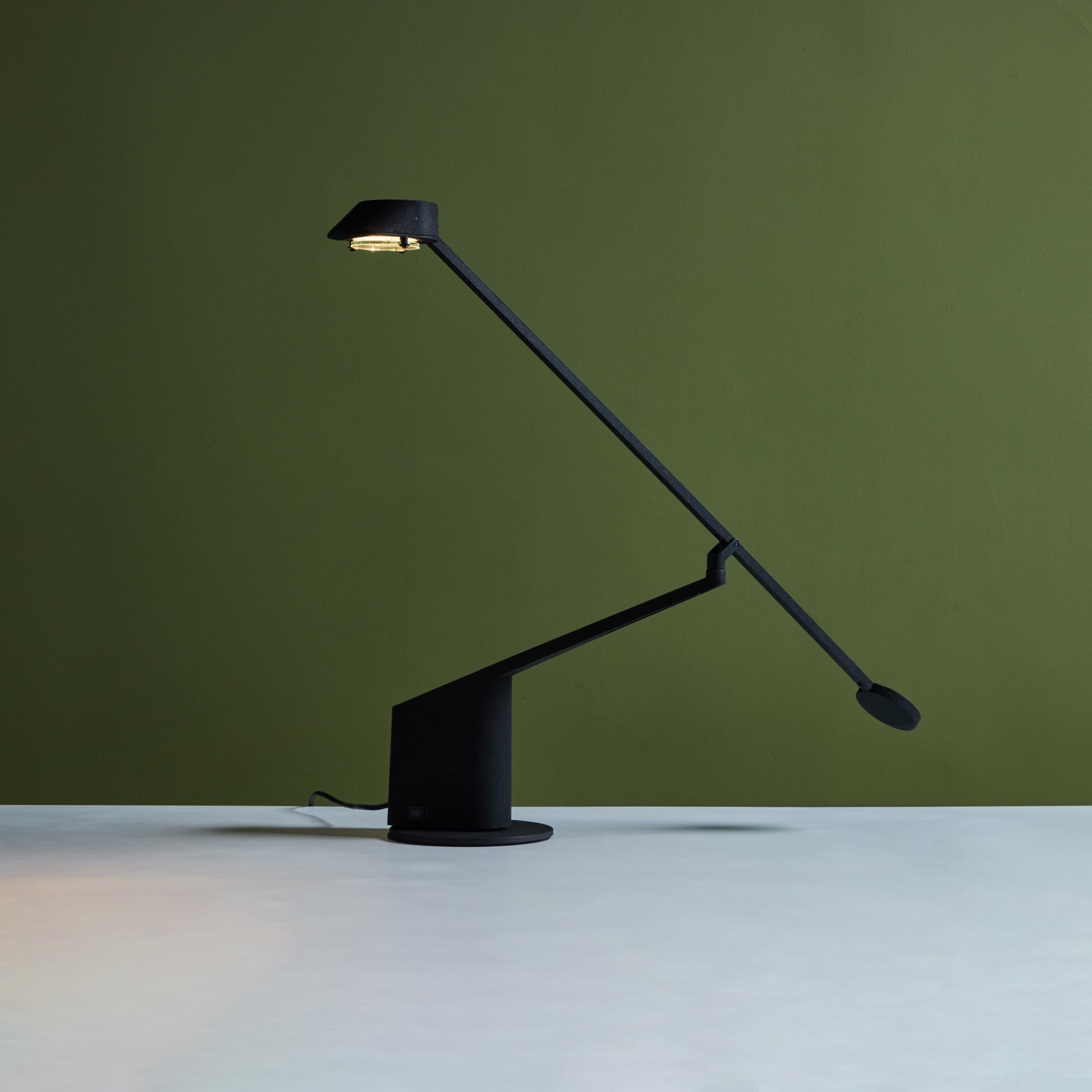 Table Lamp by Rodolfo Bonetto for Guzzini, c.1980s, Italy. The black enameled metal lamp features a 360 degree pivot with a counterweighted arm for adjustable lighting. The lamp rests on a round base.

Dimensions
33