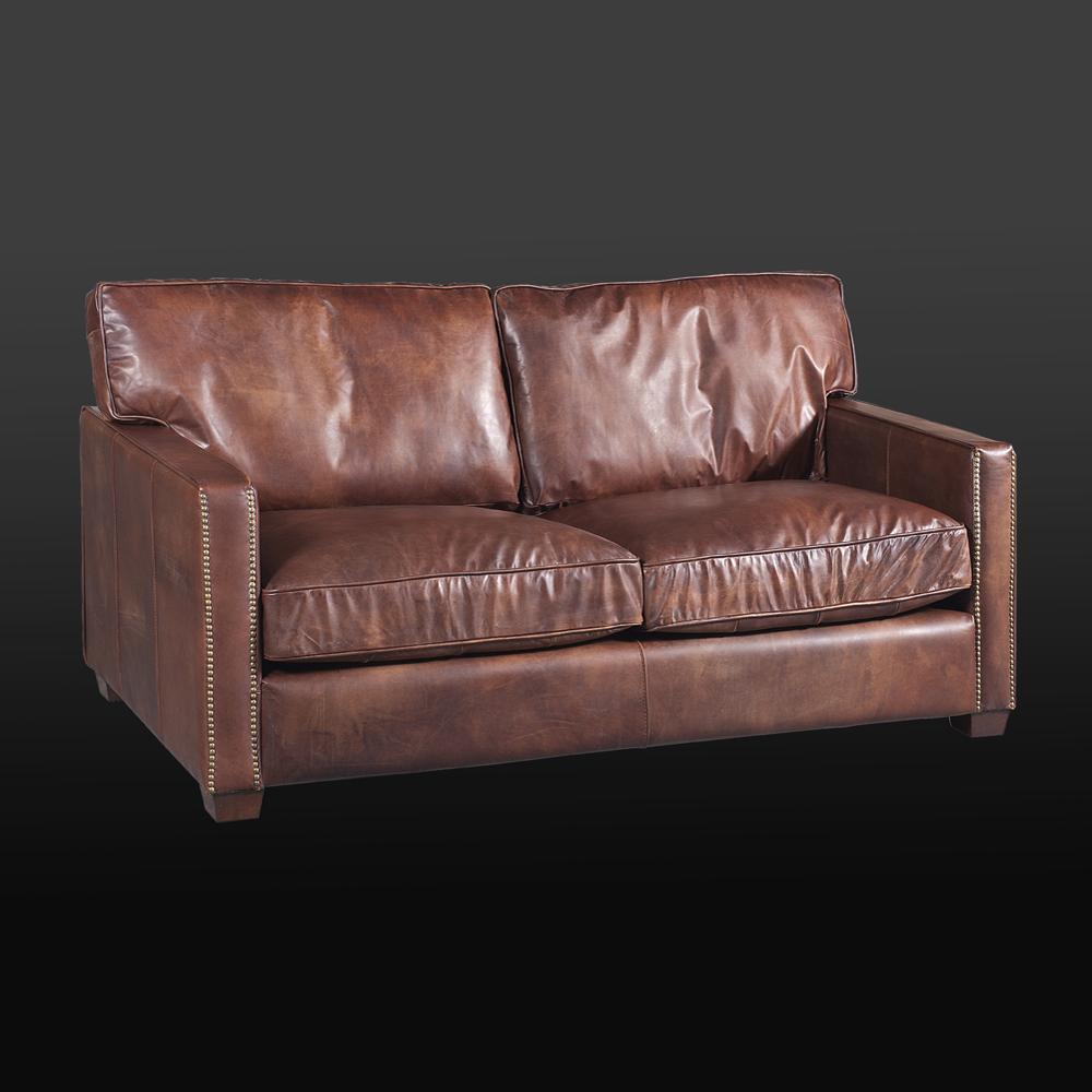 Sofa Alabama 2-seat upholstered and covered
with genuine leather in cigar finish. With brass nails.