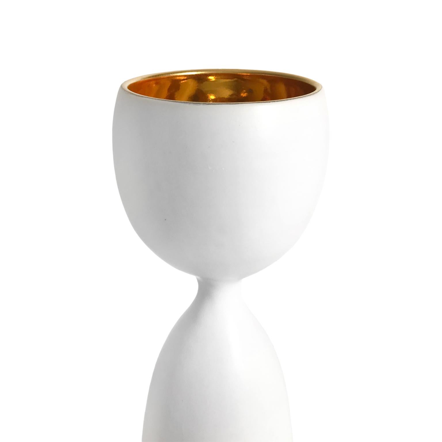 Alabaster glaze ceramic chalice #2 with 22-karat gold lustre interior by Sandi Fellman, 2018. 

Veteran photographer Sandi Fellman's ceramic vessels are an exploration of a new medium. The forms, palettes, and sensuality of her photos can be found
