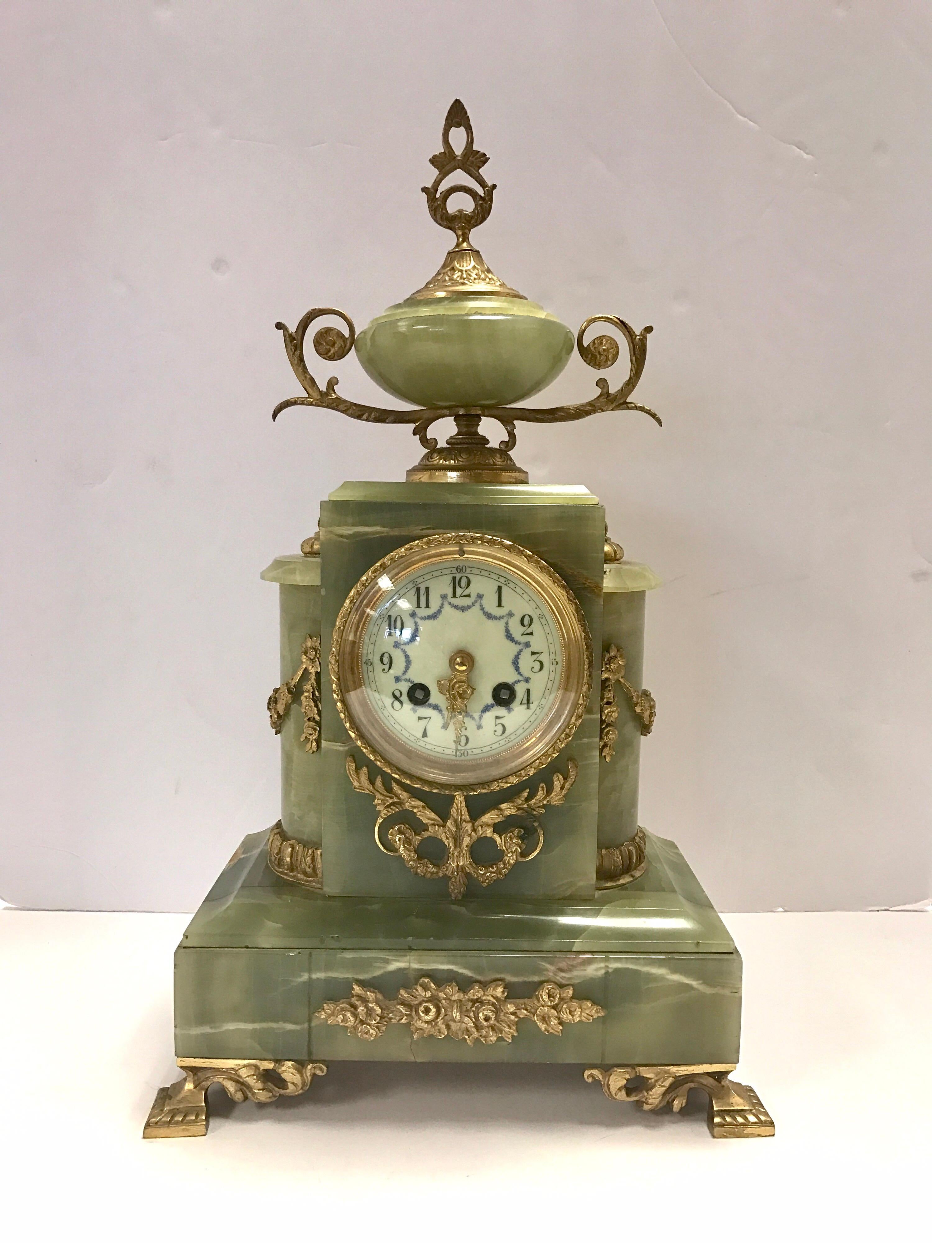 A very impressive French Louis XVI green onyx and bronze gilt ormolu clock set comprising of two four branch candelabra garnitures and a mantel clock in the Louis XVI style. The candelabras have a scrolling leaf and floral branch design. The clock