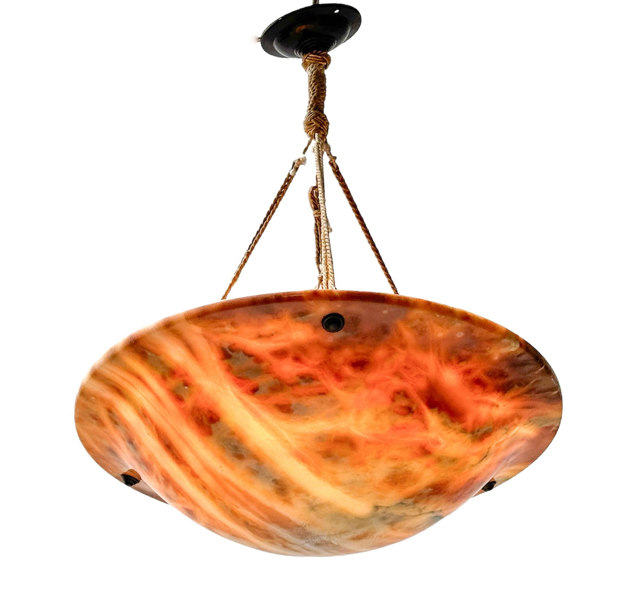 Stunning and rare Art Nouveau pendant light.
Striking Dutch design from the 1900s.
Original multi-colored alabaster shade with original brass canopy and rope cords.
This wonderful Art Nouveau pendant light is in very good original condition with